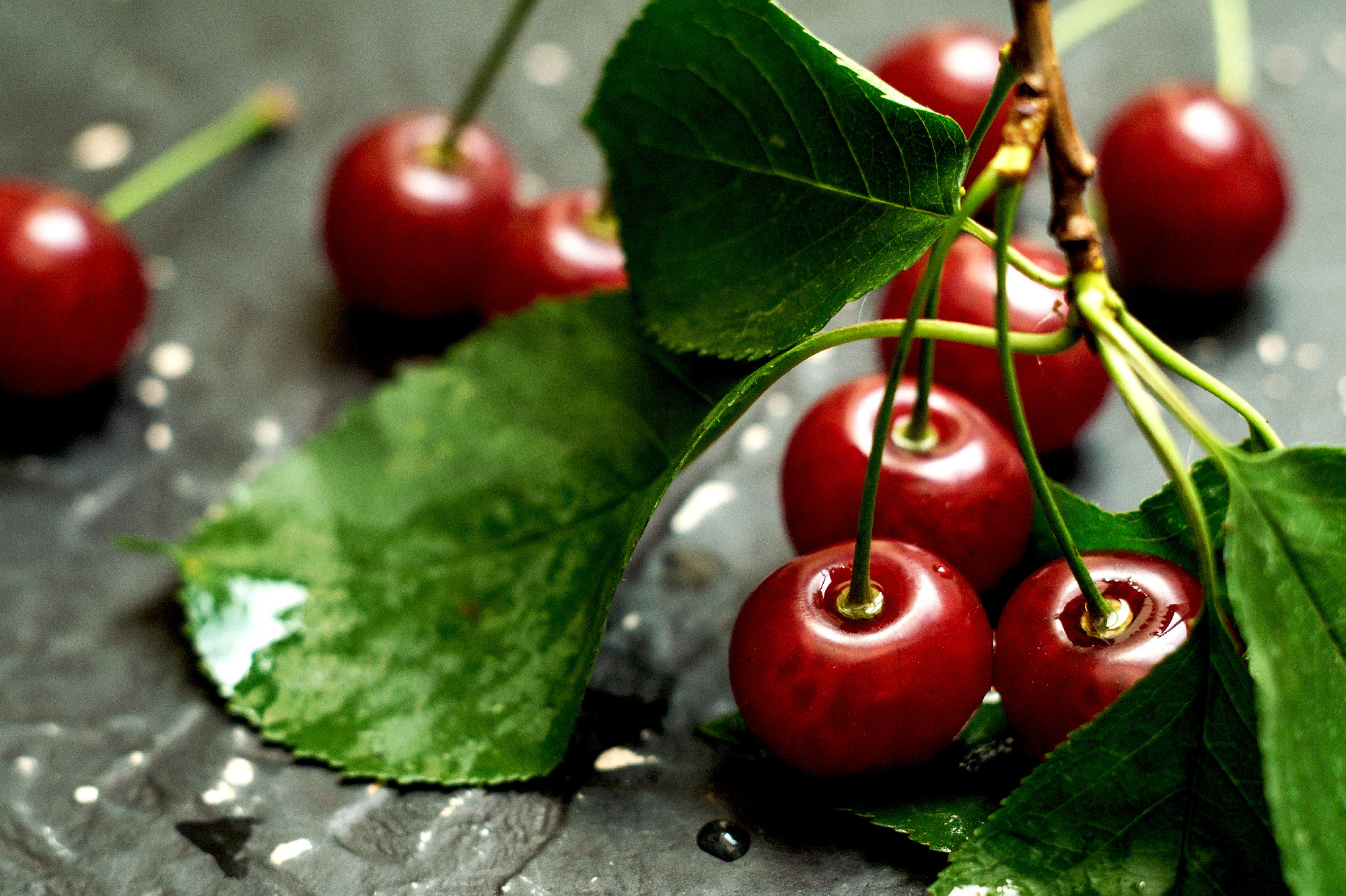 Ripe cherries on a dark table