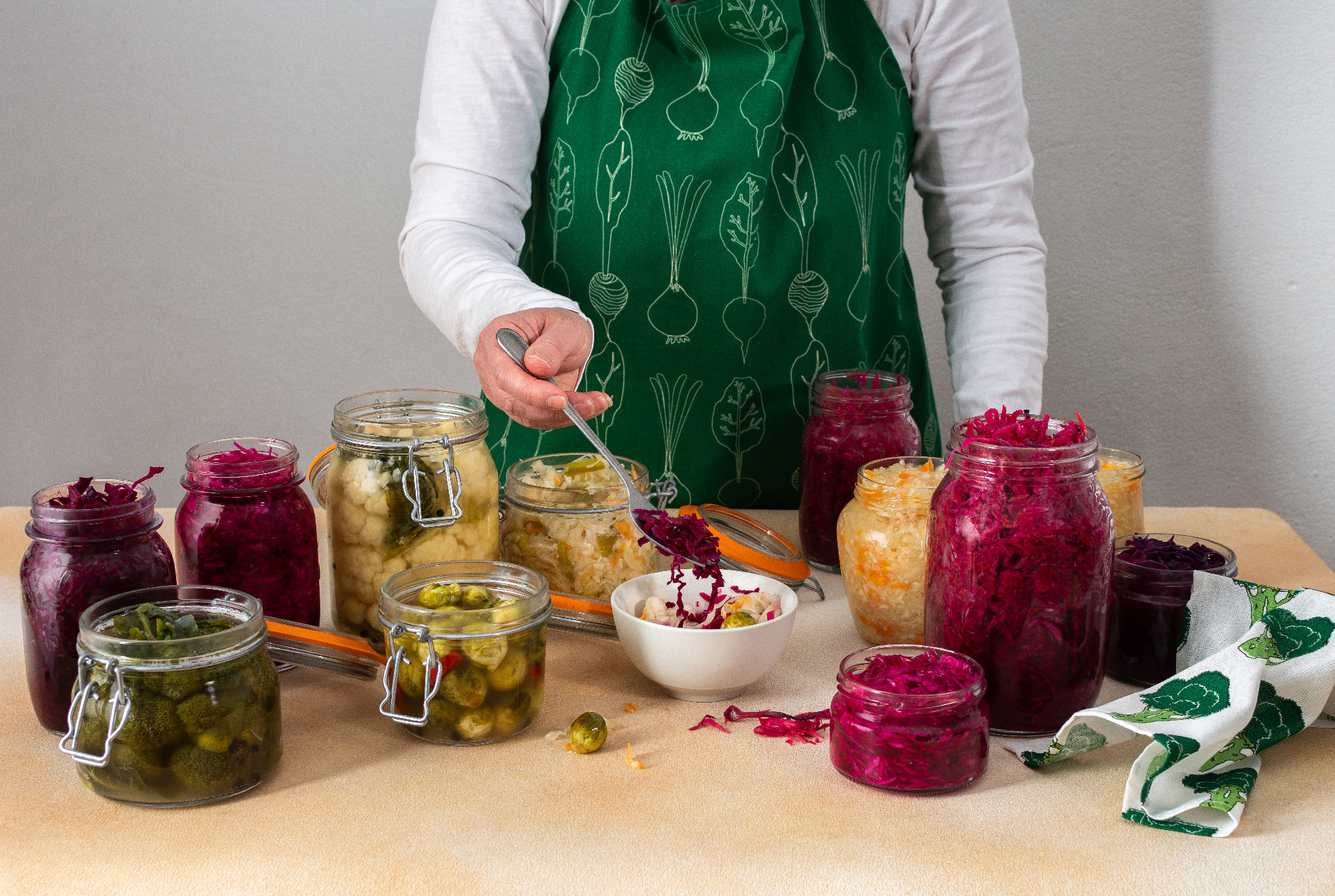 Woman fermenting fresh vegetables