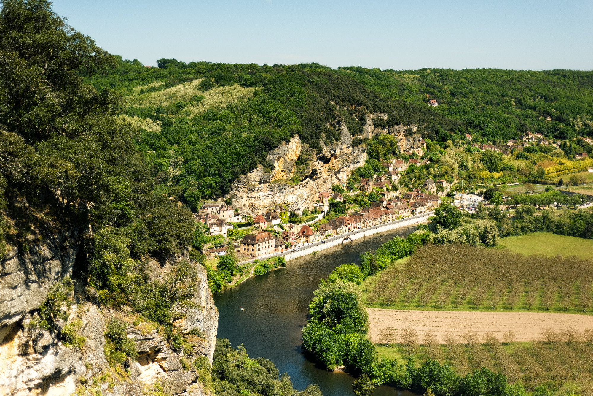 View of one of most beautiful villages of France La Roque-Gageac, Dordogne, Aquitaine from Marqueyssac gardens. Countryside french landscape with Dordogne river, fields and hills. Travel destination.
