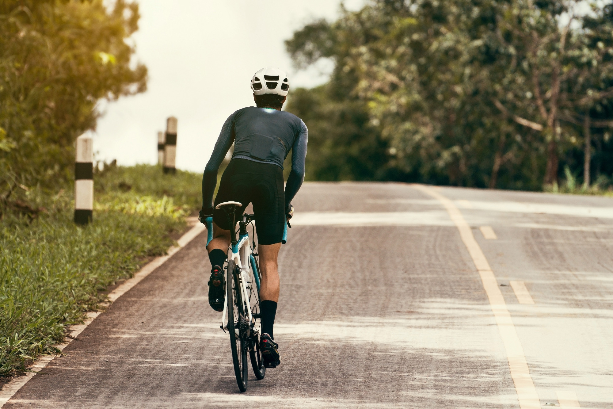 Cyclists are cycling, climbing up to the top.
