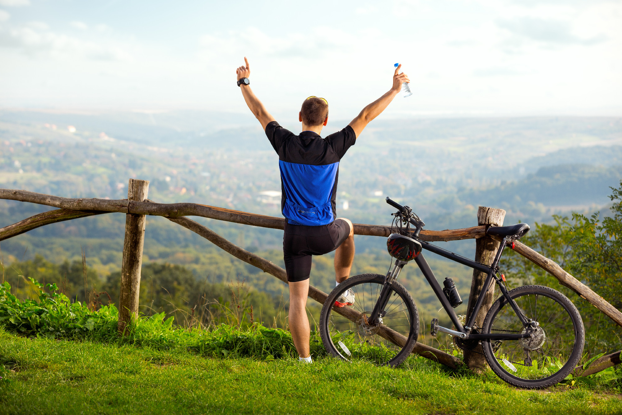 happy man biker raised hands up in joy