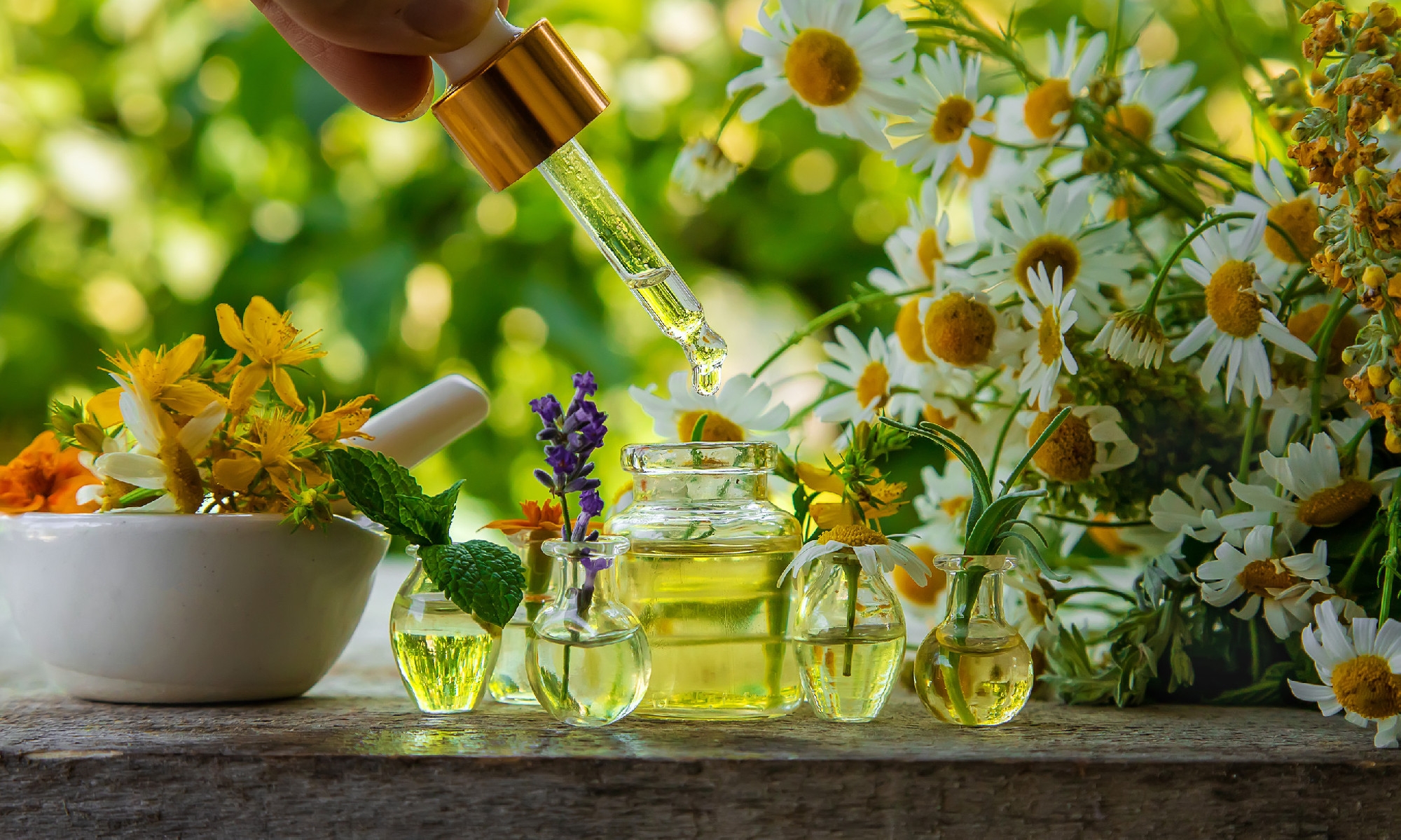 Essential oils and herbal extracts in small bottles. Selective focus.
