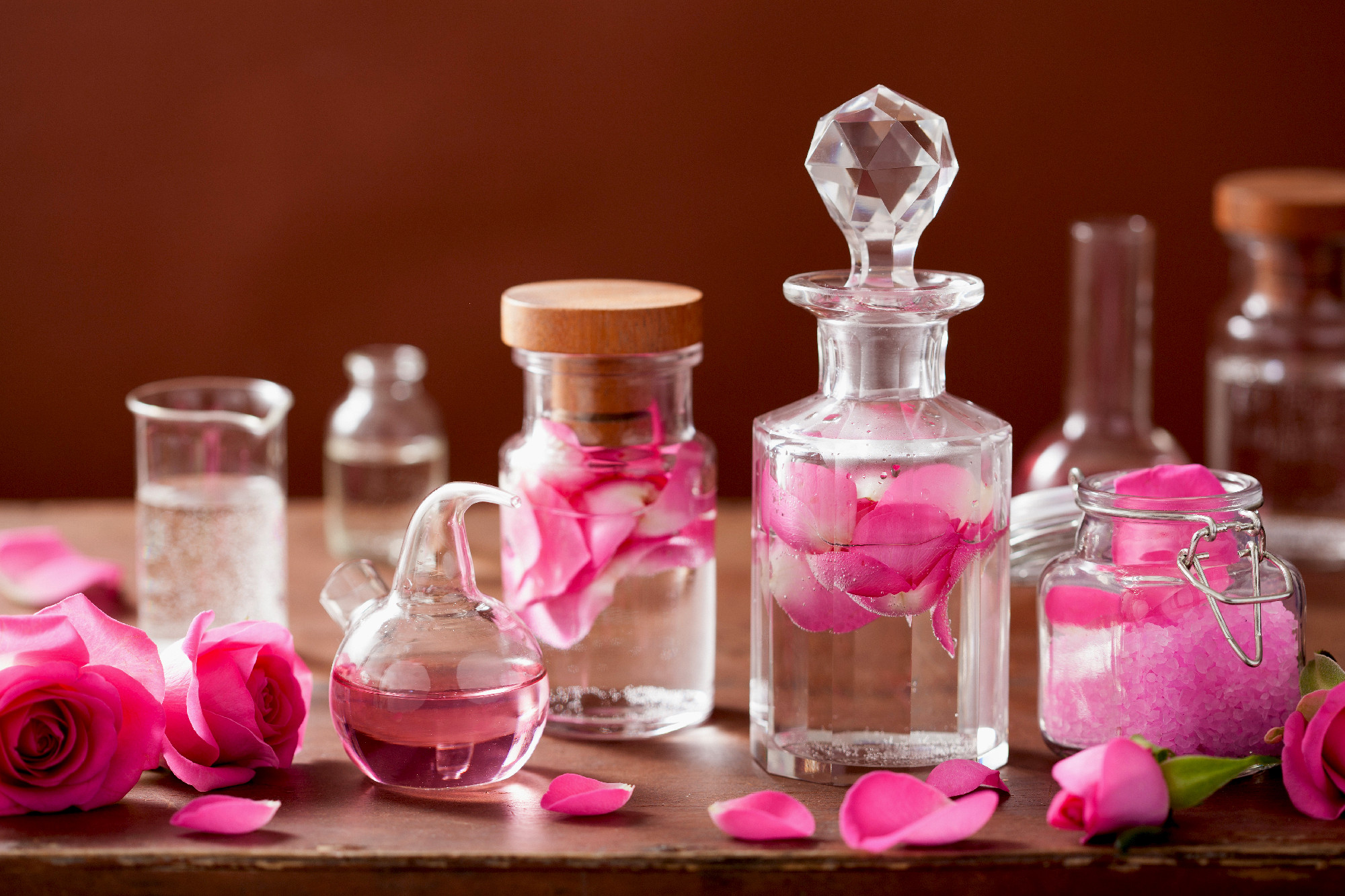 alchemy and aromatherapy set with rose flowers and flasks