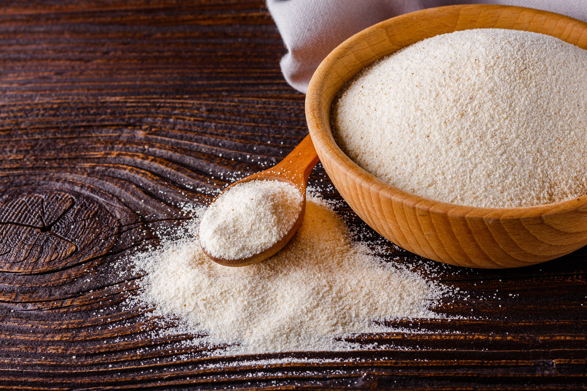 natural organic semolina on dark wooden rustic background