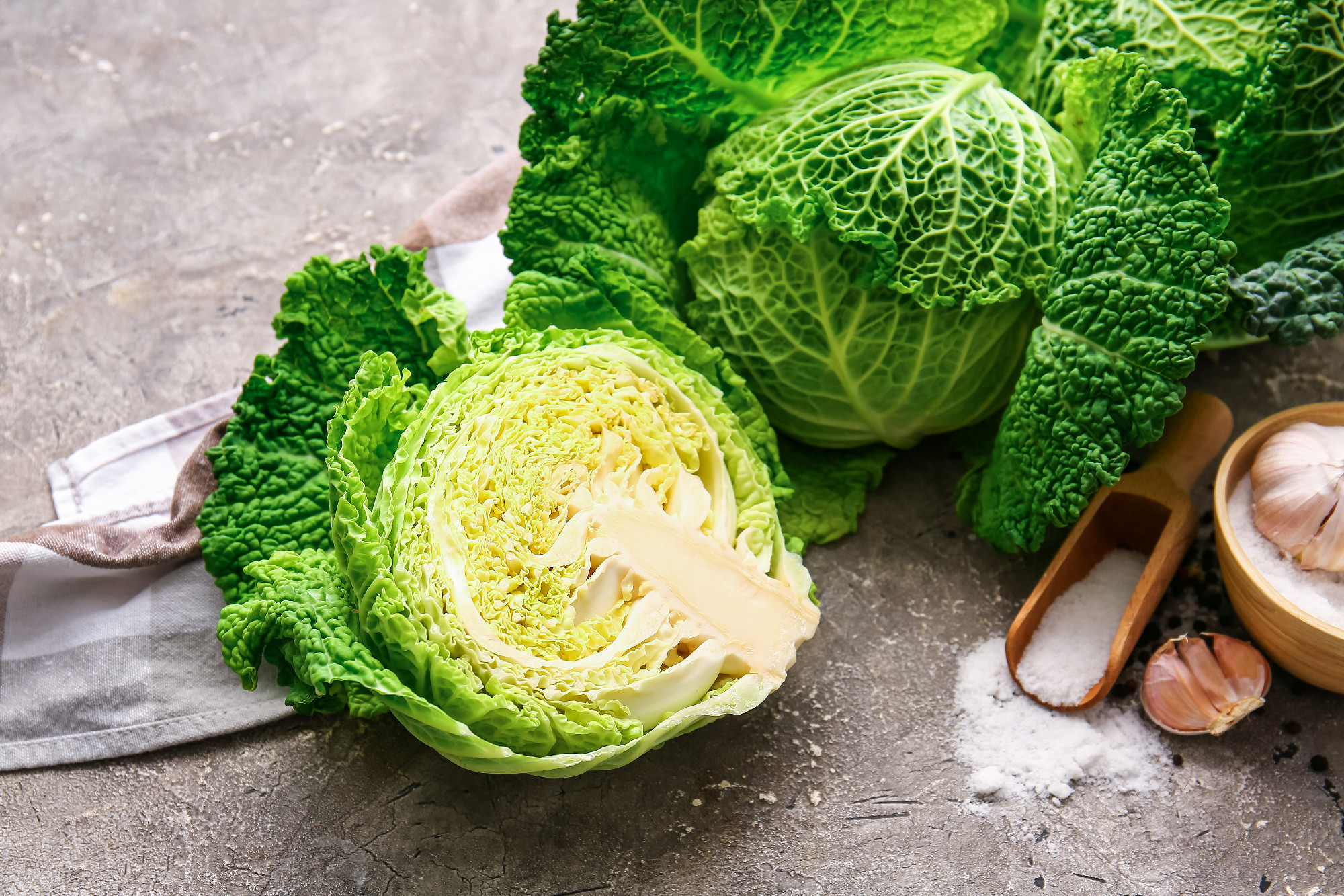 Half of fresh savoy cabbage on grunge background�