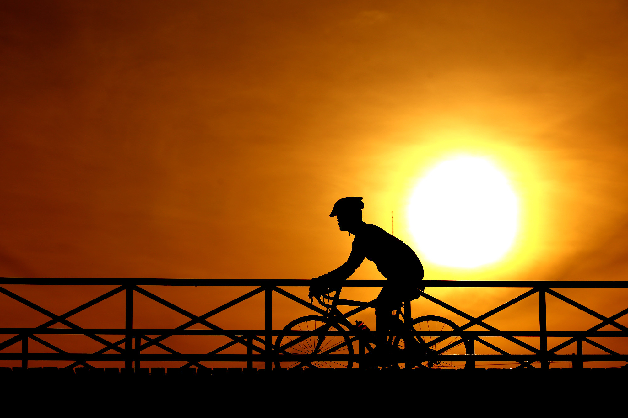 silhouette of a cyclist at sunset