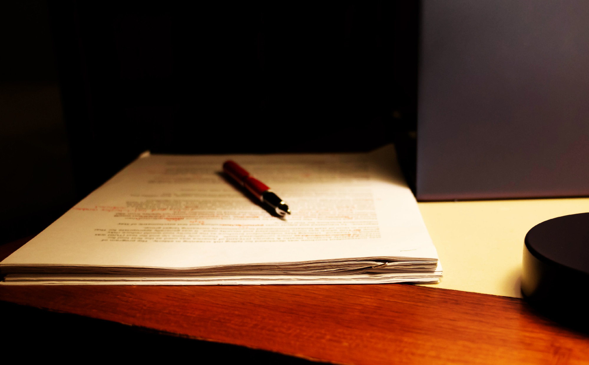 blur proofreading paper on table