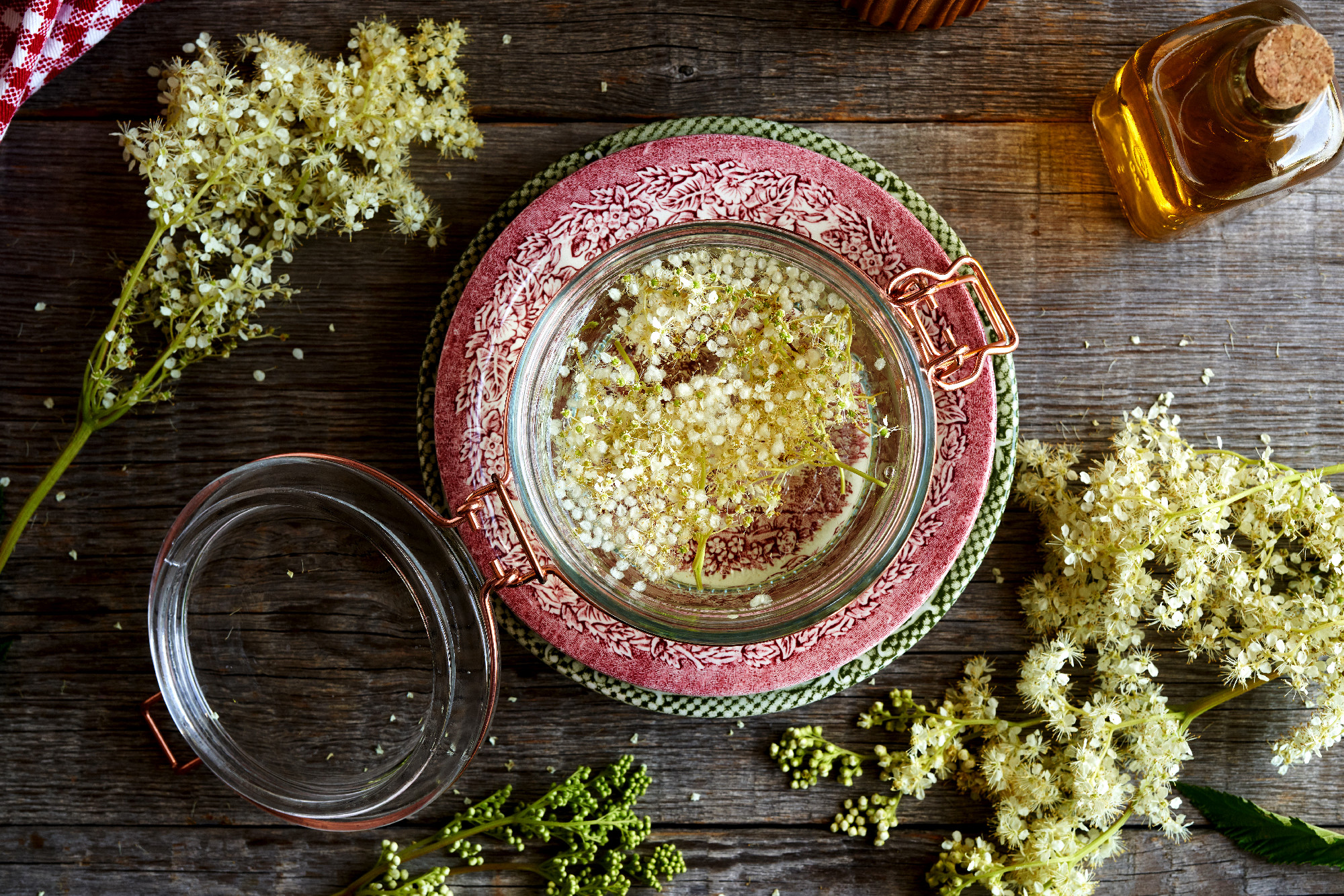 A jar filled with meadowsweet blossoms and alcohol - preparation
