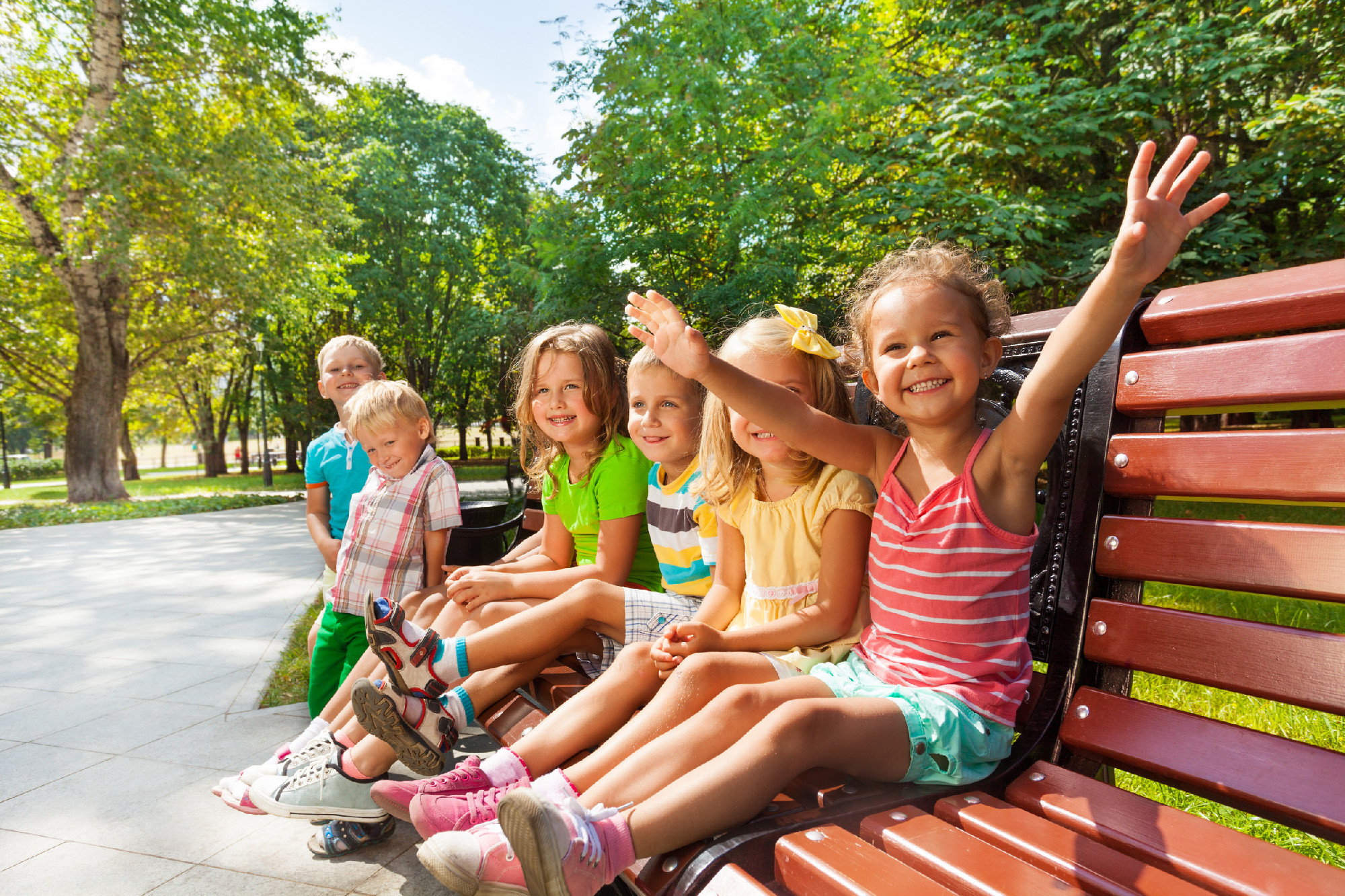 Boys and girls on the bench in park