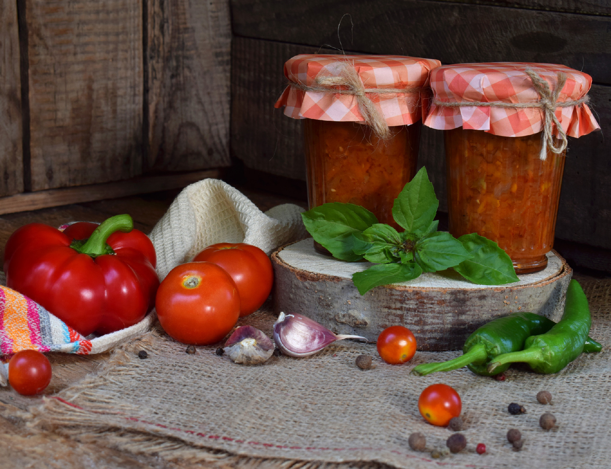 Jars of tomato sauce with chili, pepper and garlic. Bolognese sauce, lecho or adjika. Preservation. Canning