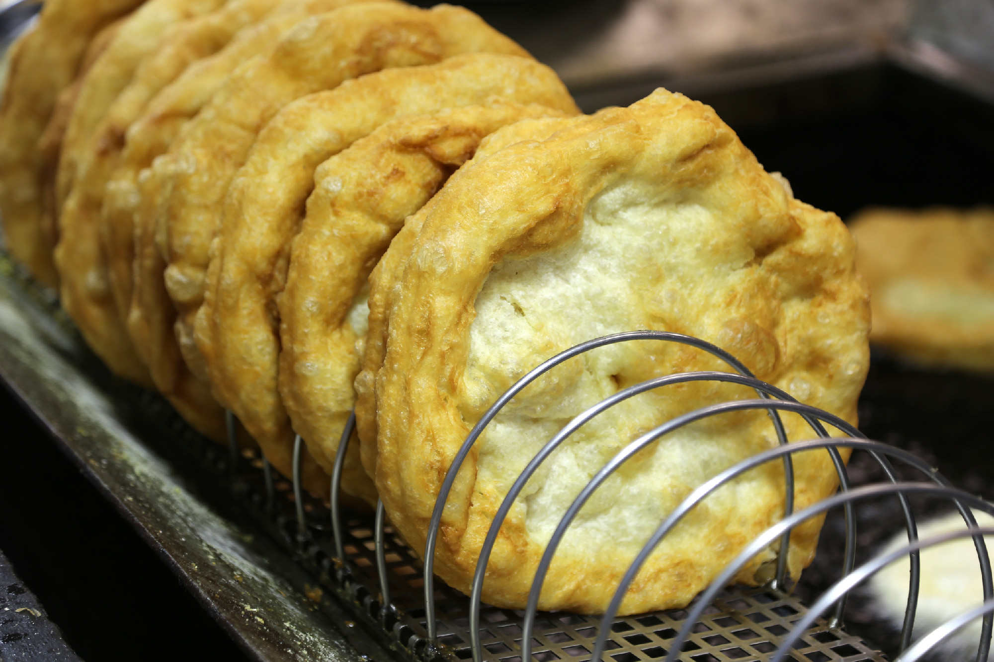 Hungarian speciality langos deep fried flat bread ready to taste