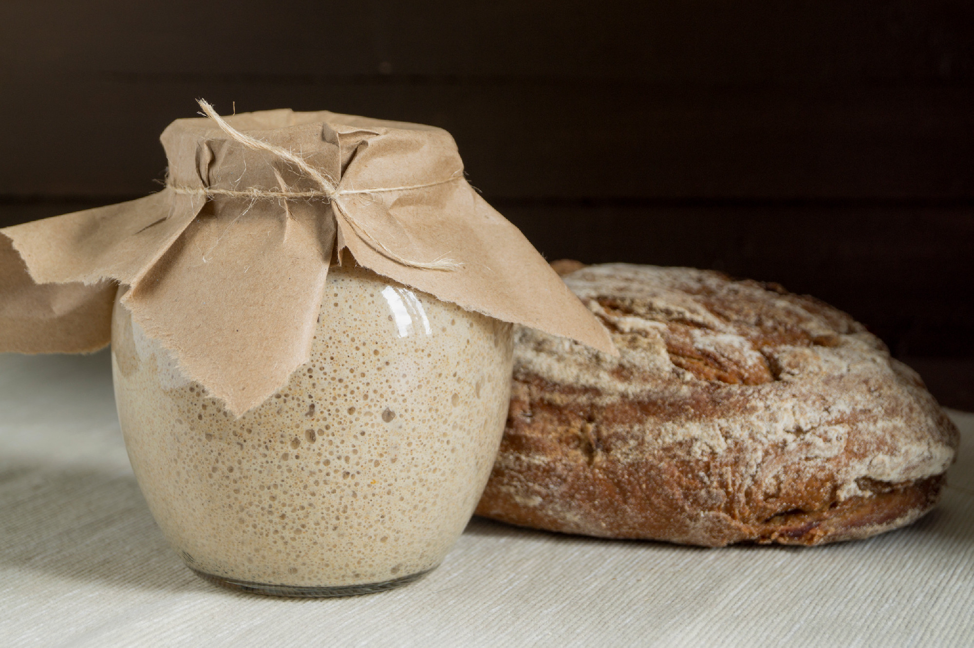Active rye sourdough in a glass jar for homemade bread.