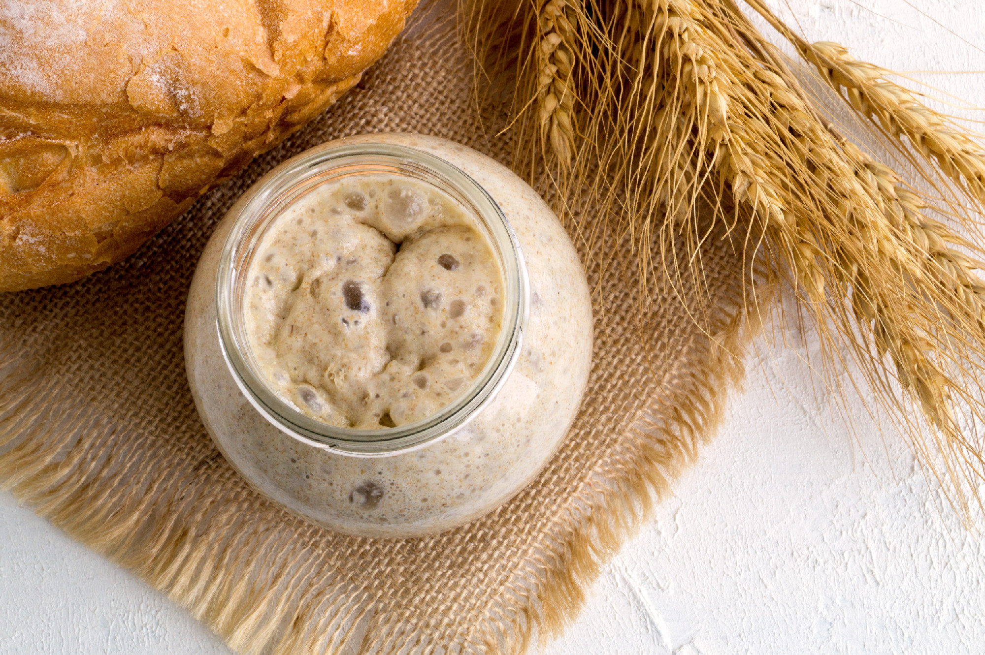 Active rye sourdough in a glass jar for homemade bread.