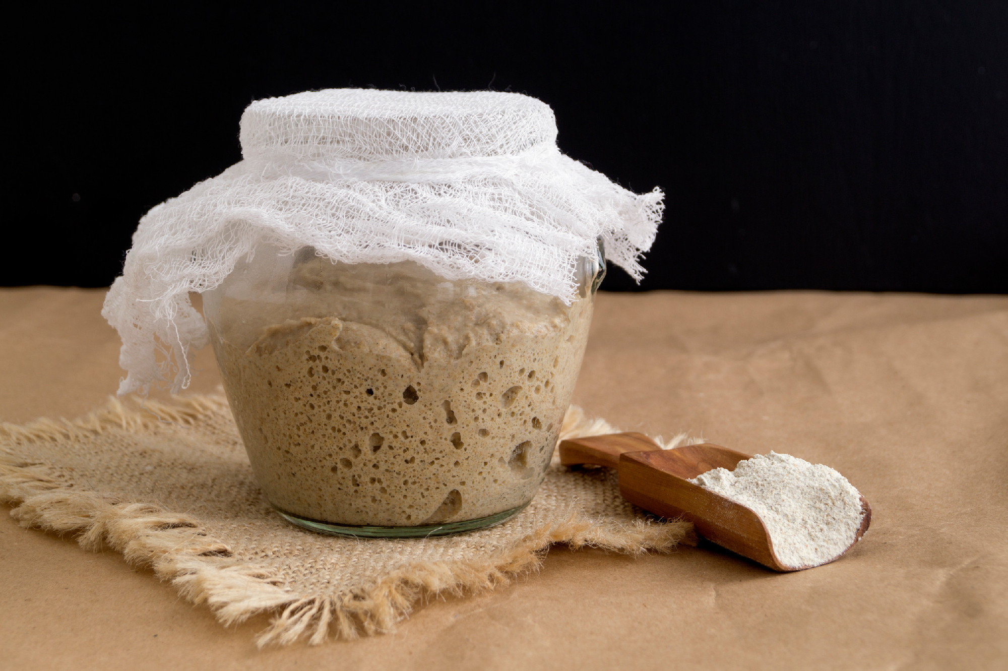 Active rye sourdough in a glass jar for homemade bread.