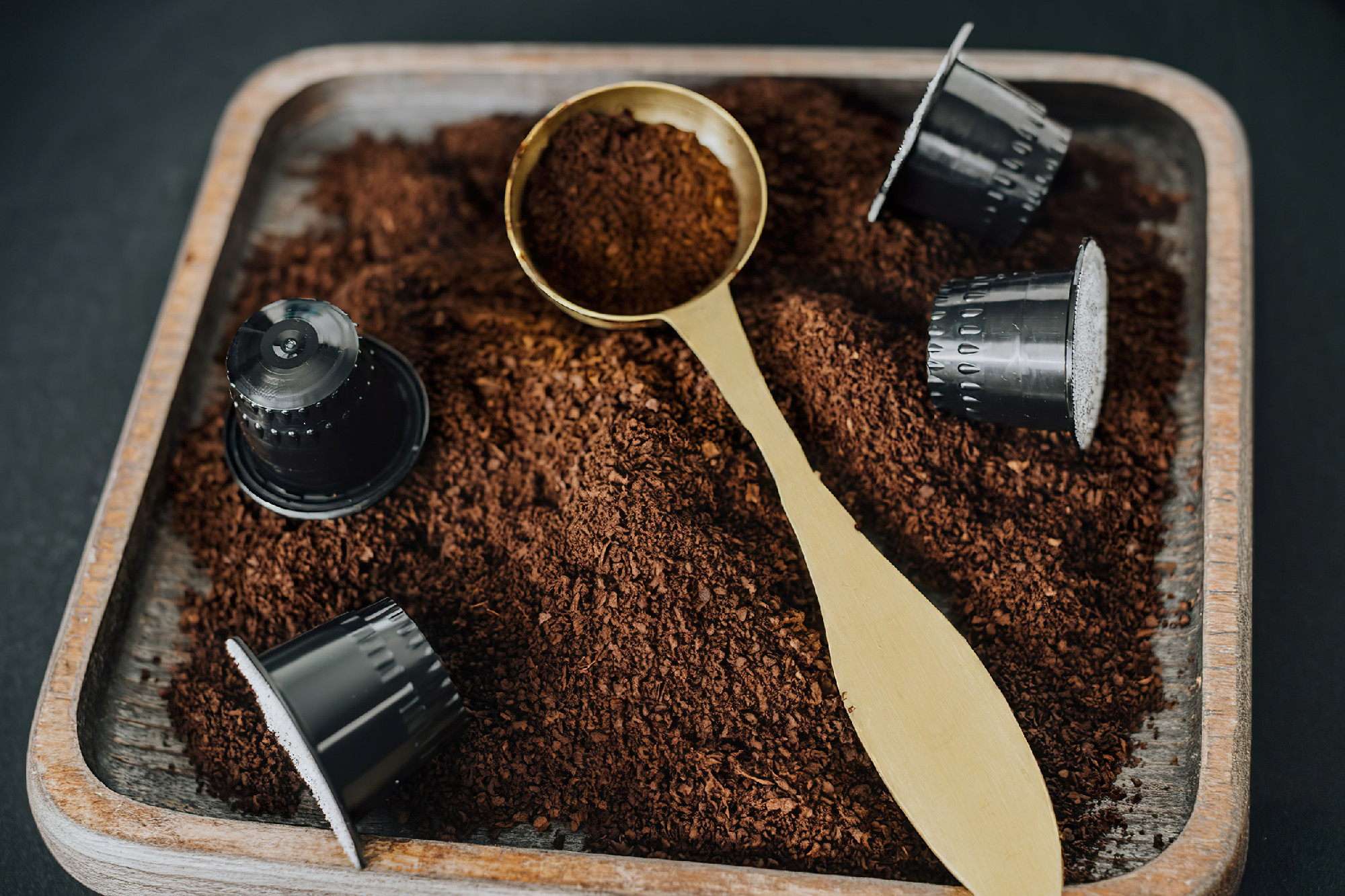 Freshly ground coffee on a wooden tray