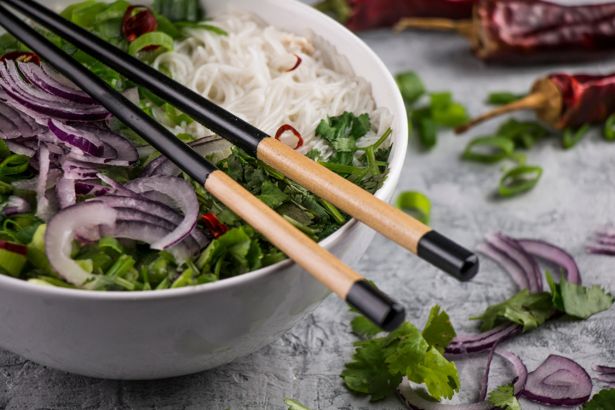 Served bowl of vietnamese soup pho ga with spring onion, chilli 
