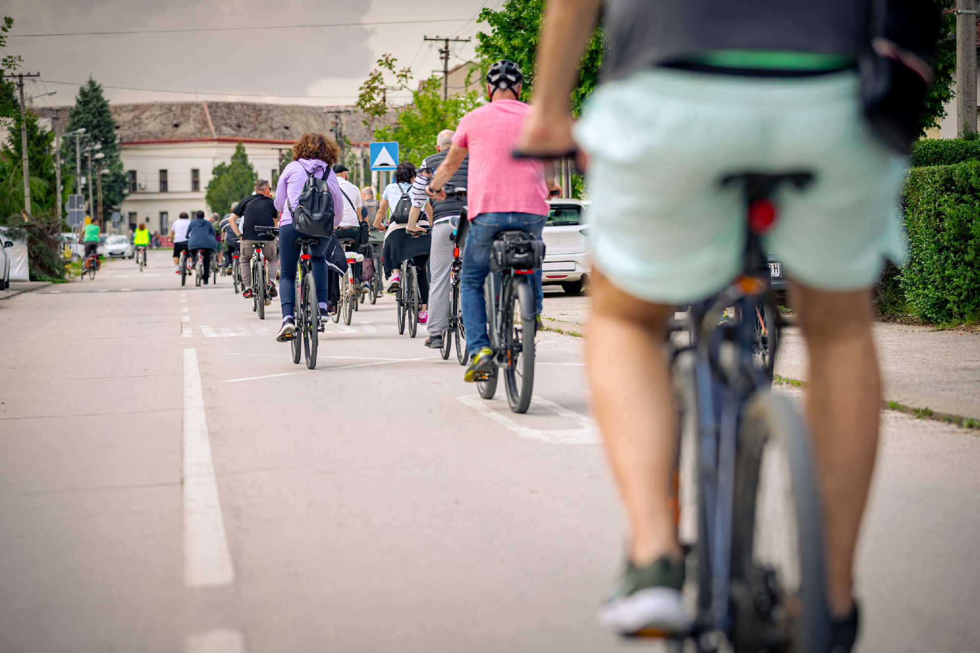 Group of cyclists on city road, street, asphalt