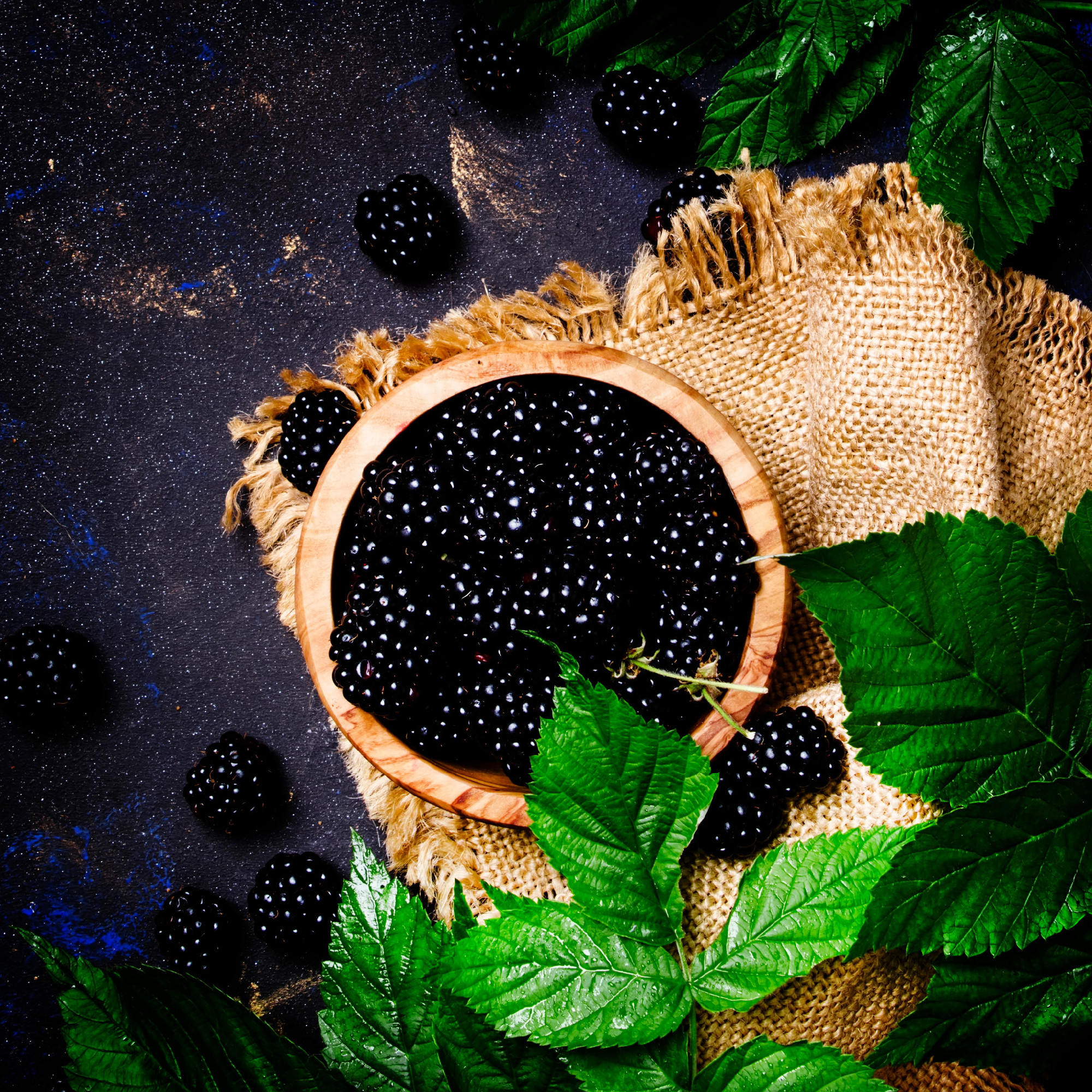 Fresh blackberries with green leavesl, rustic style, food backgr