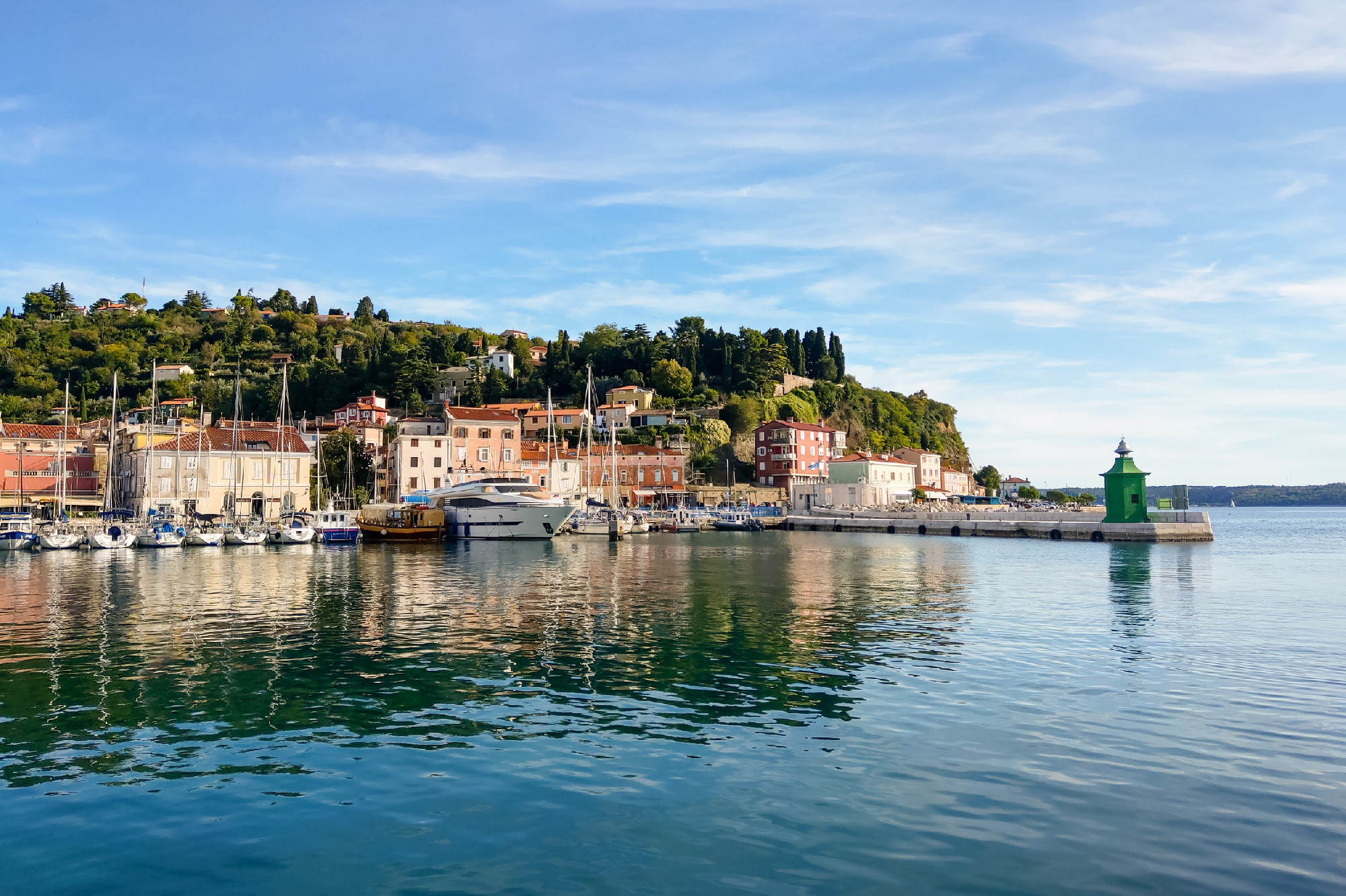Piran, Slovenia, September 10, 2019: beautiful promenade and pier with boats on the shores of the Andriatic Sea.