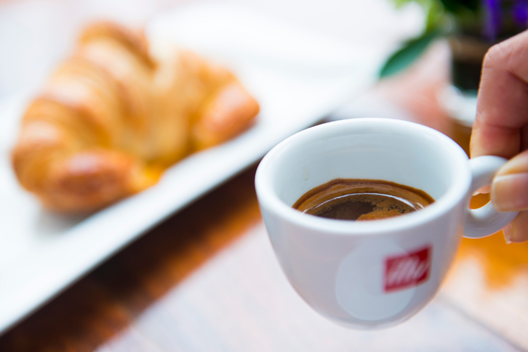 espresso coffee in small mug with croissant