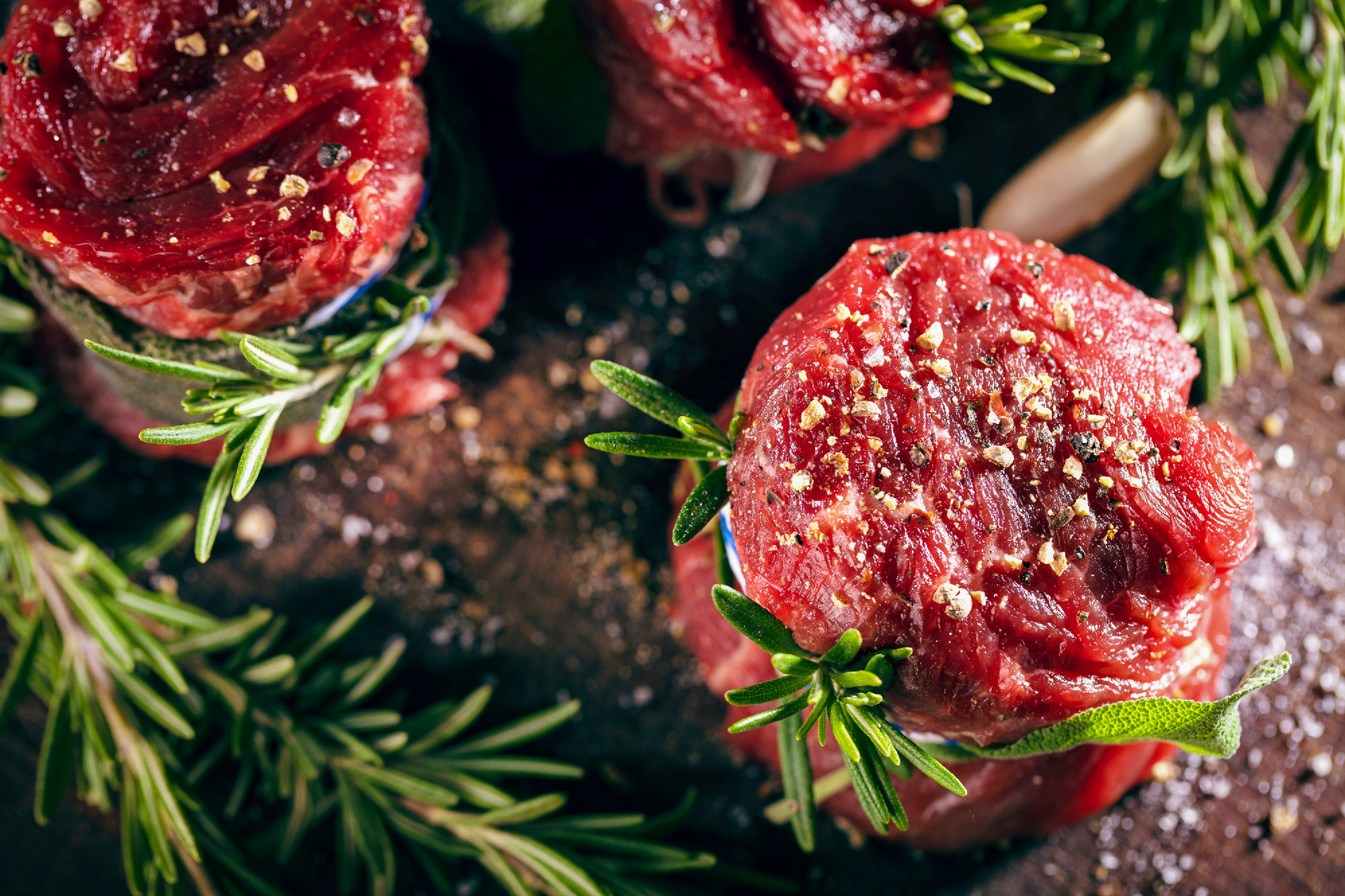 Fresh fillet steak on wooden table ready to grill.