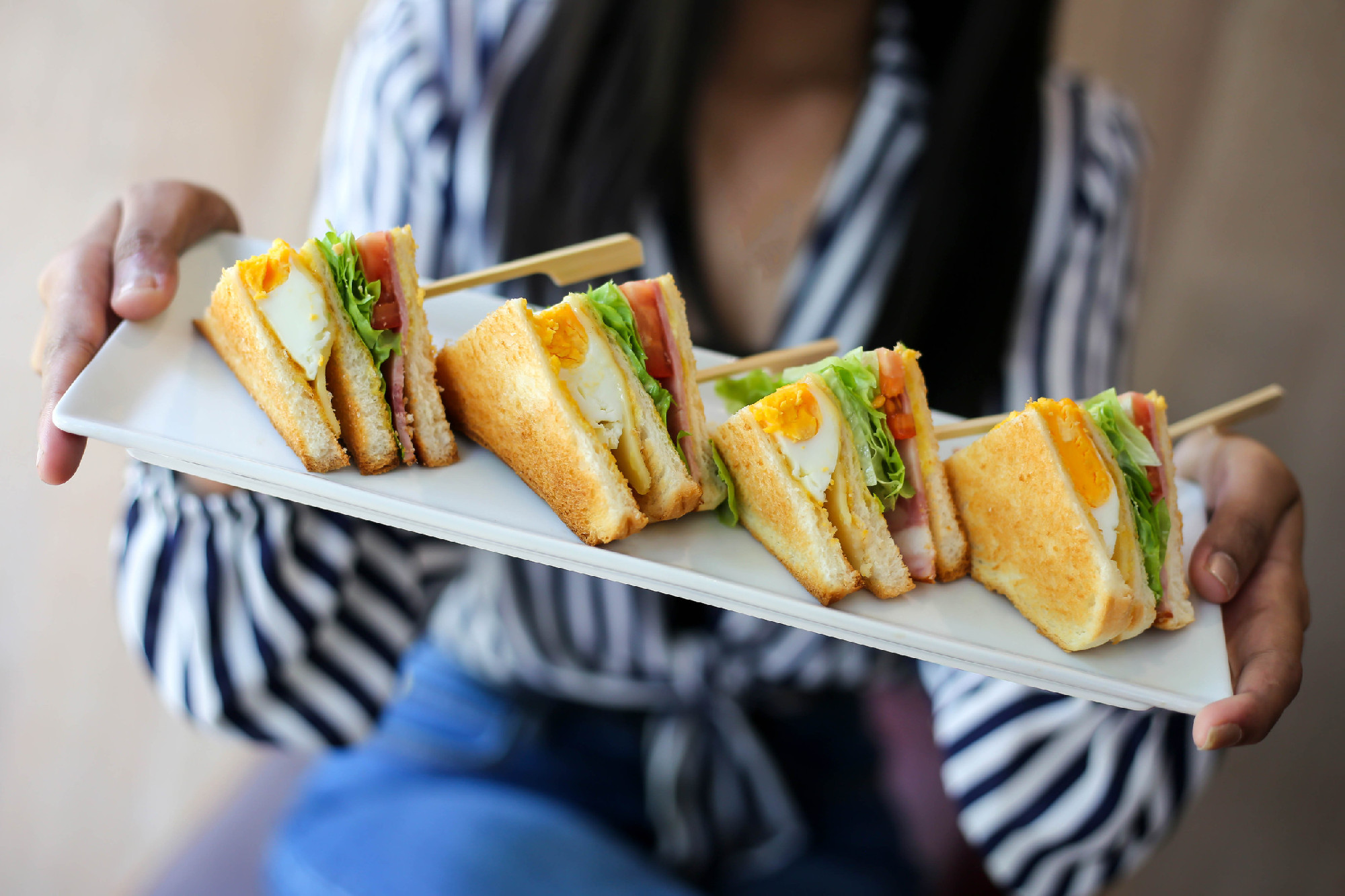 Club sandwich on wooden table.