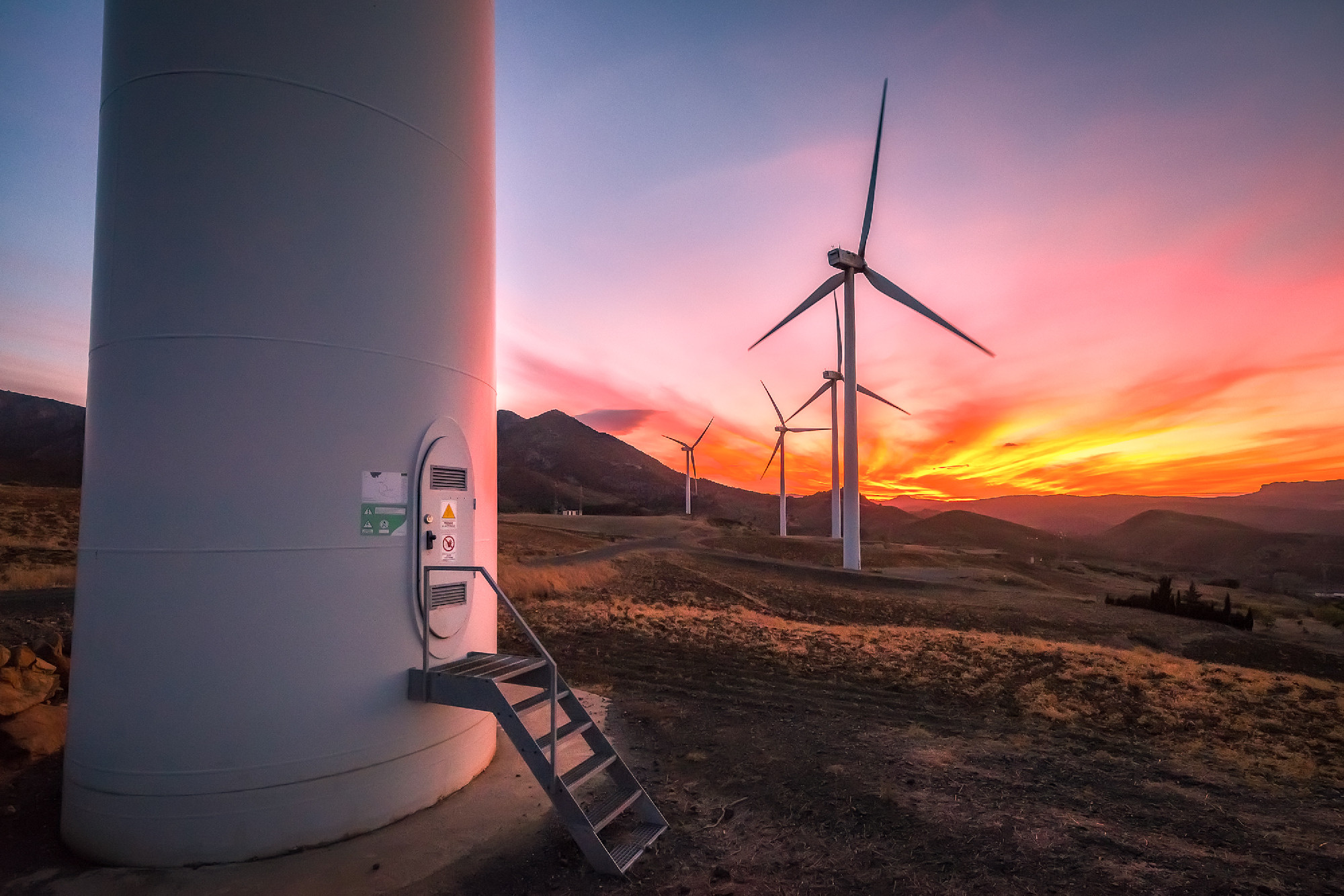 Colorful sunset with wind turbines