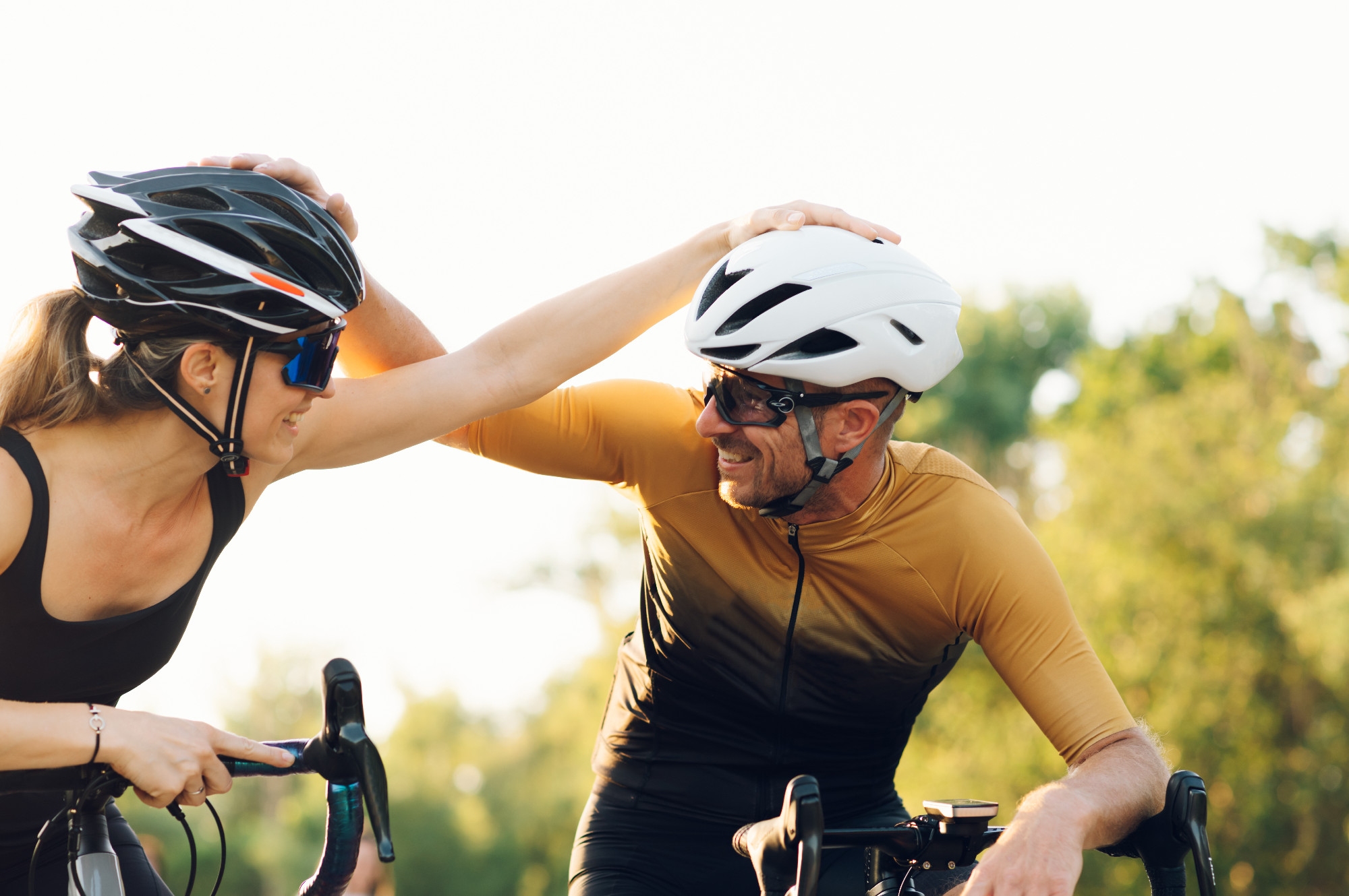Happy couple riding road bicycles and taking a break during a su
