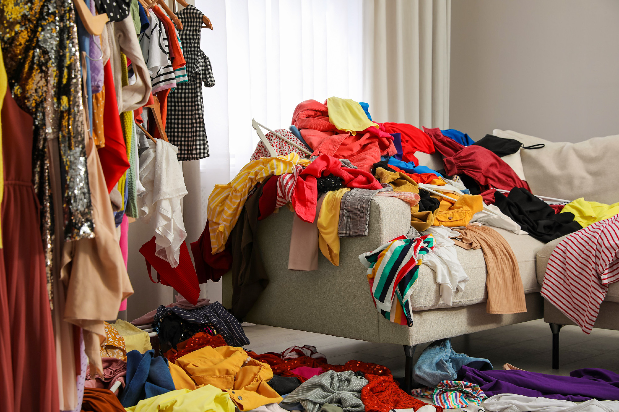 Mess of clothes all over room. Fast fashion