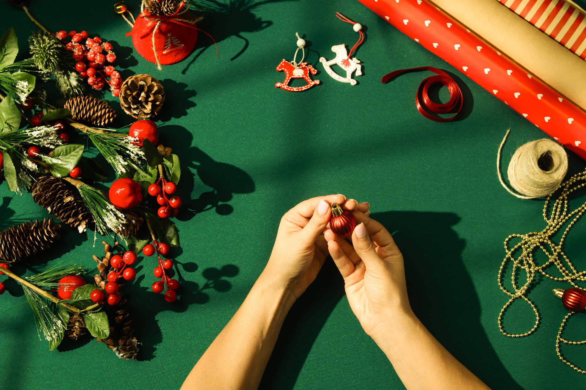 Hands holding red ornament for Christmas decoration