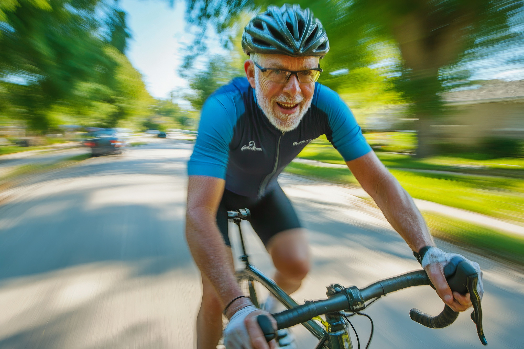 A senior Caucasian cyclist rides swiftly on a gravel bike, gripp