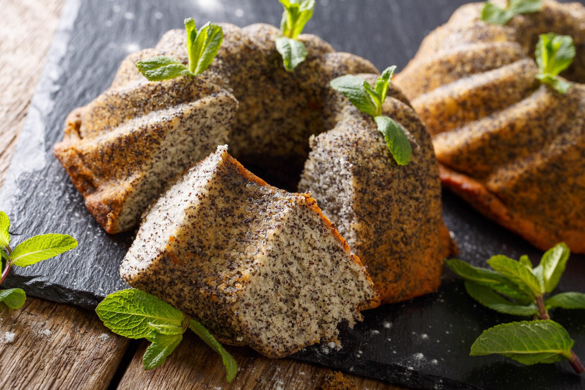 Homemade bundt cake with poppy and mint closeup. horizontal