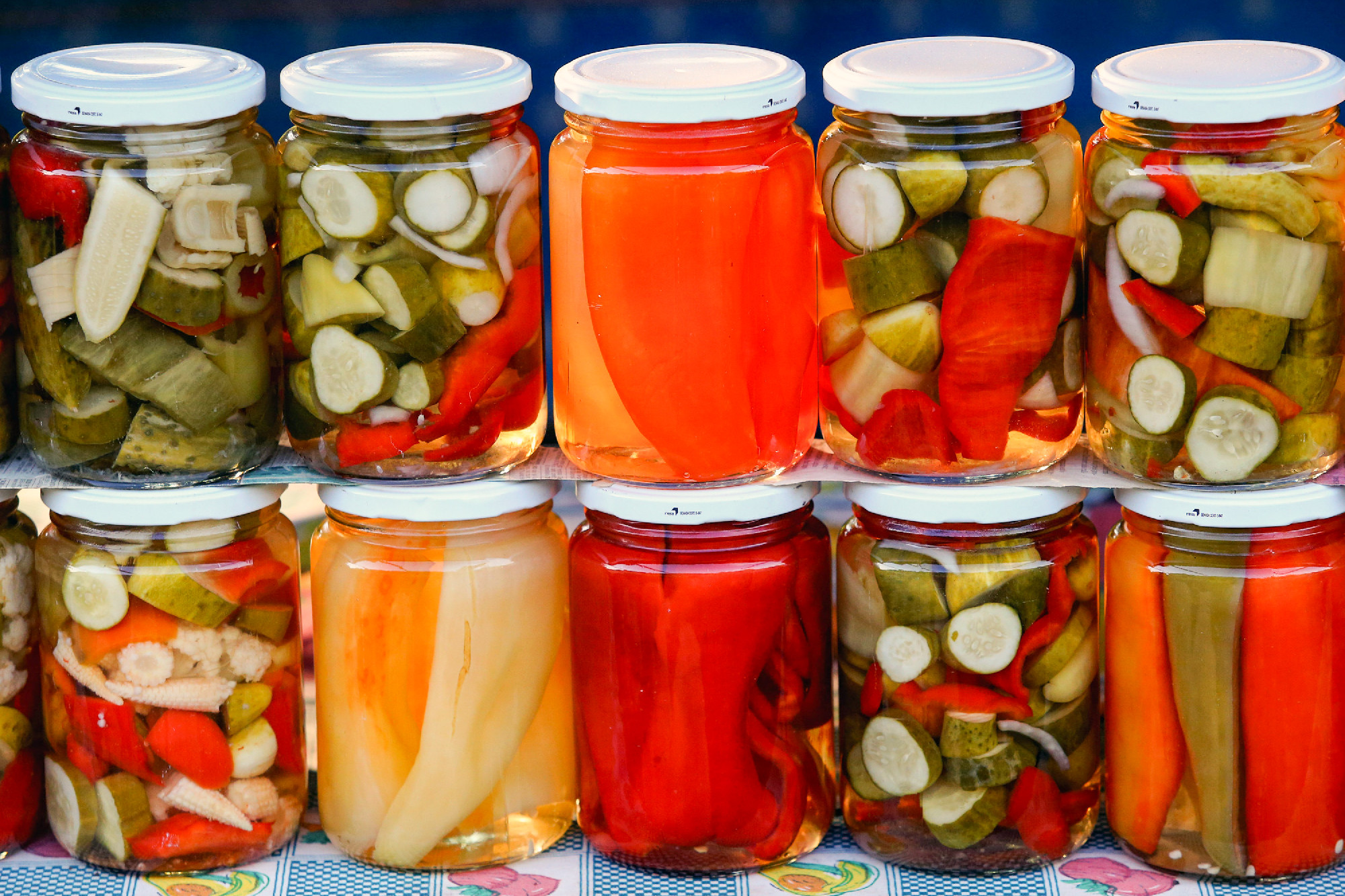 Close up of pickled vegetables in glass jars