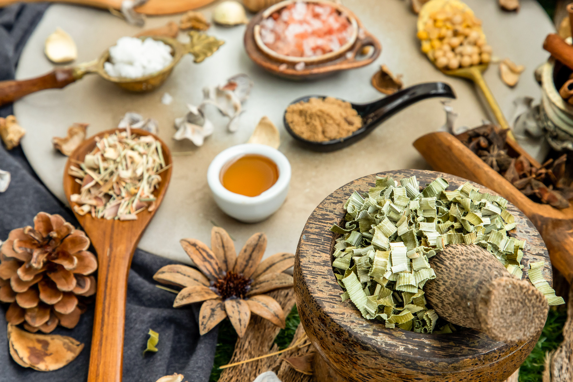 Various spices and herbs in rustic style with honey on balck bac