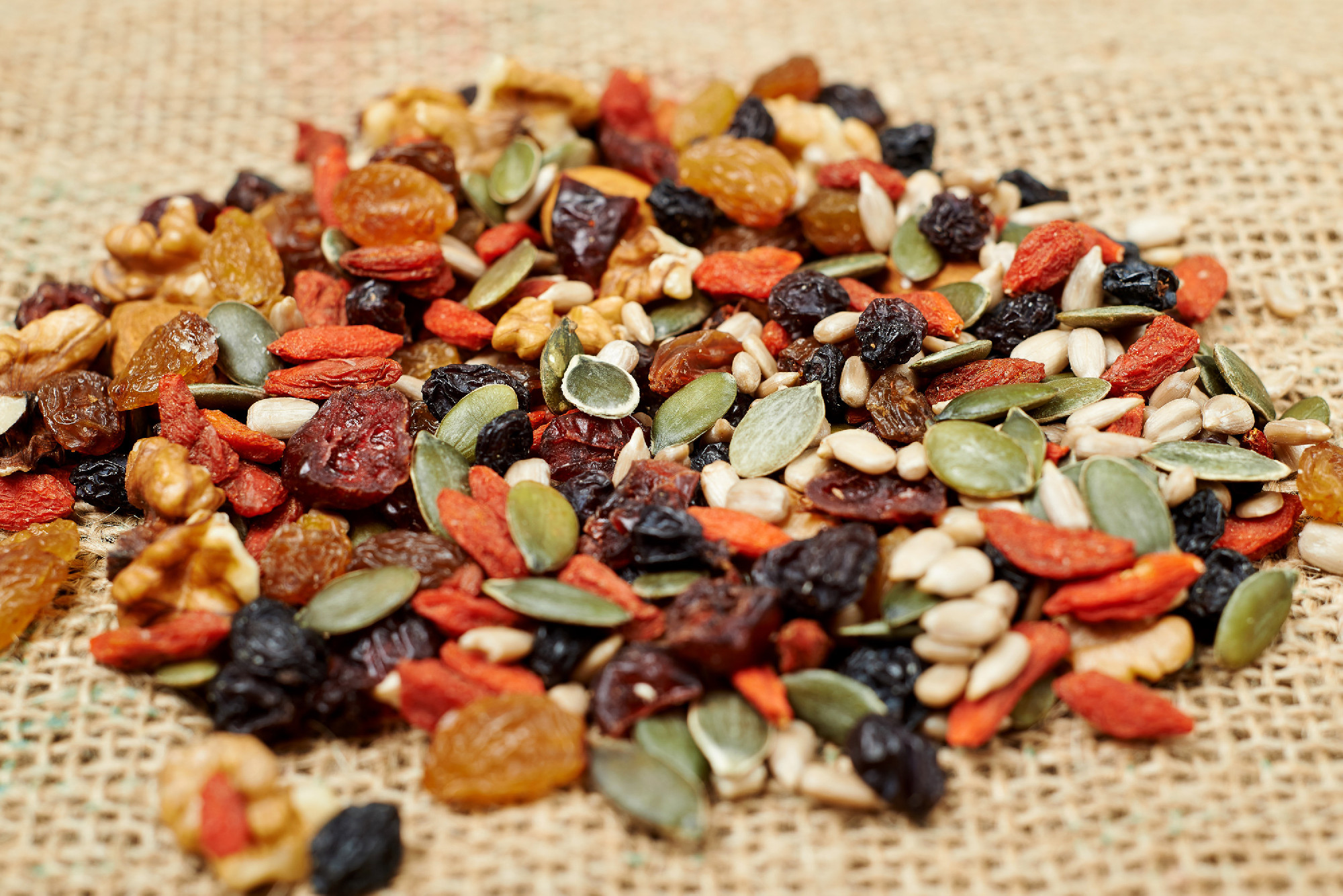 mix nuts seeds and dry fruits, on a wooden table