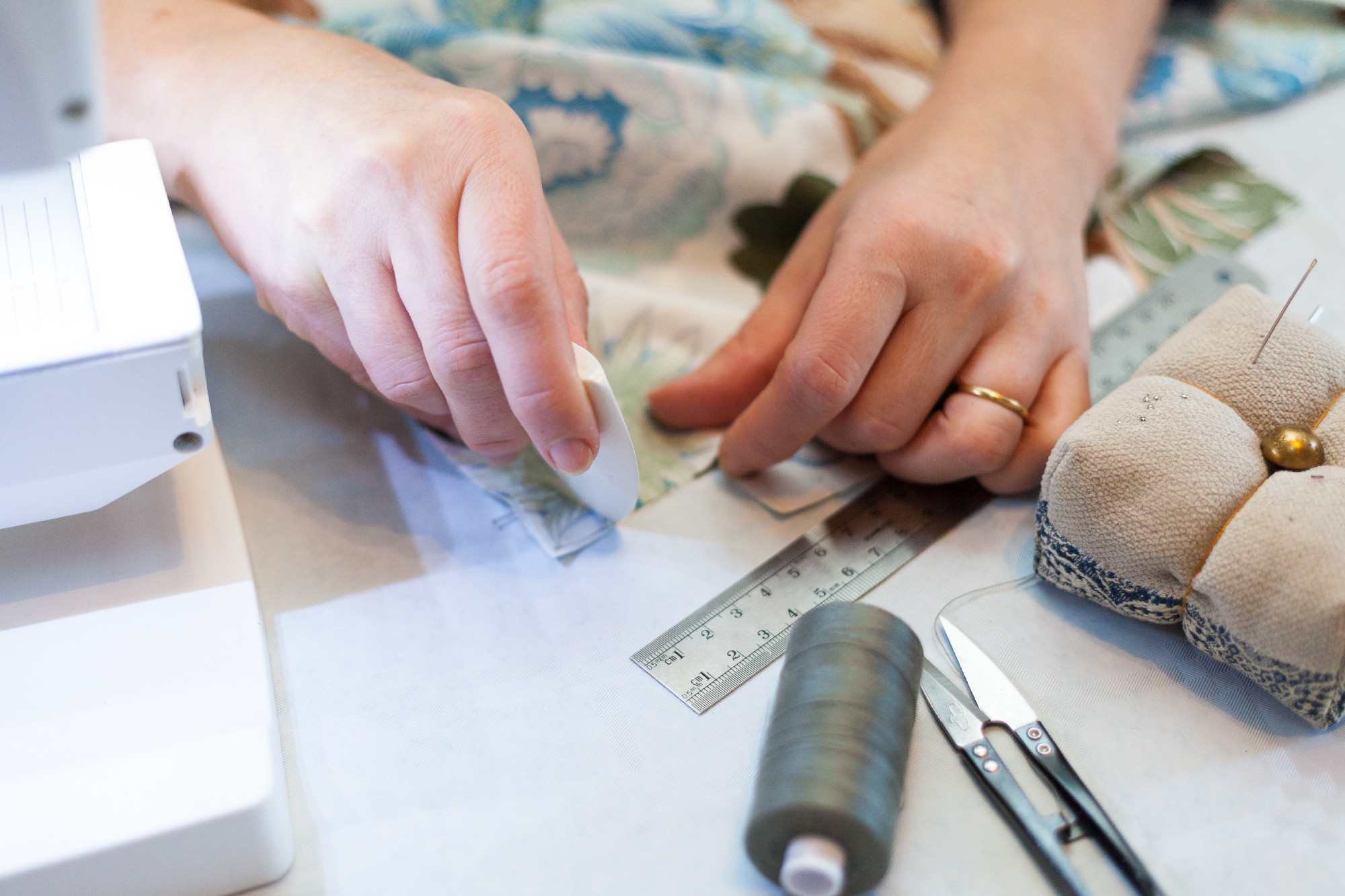 Seamstress hands at work, threads and needles