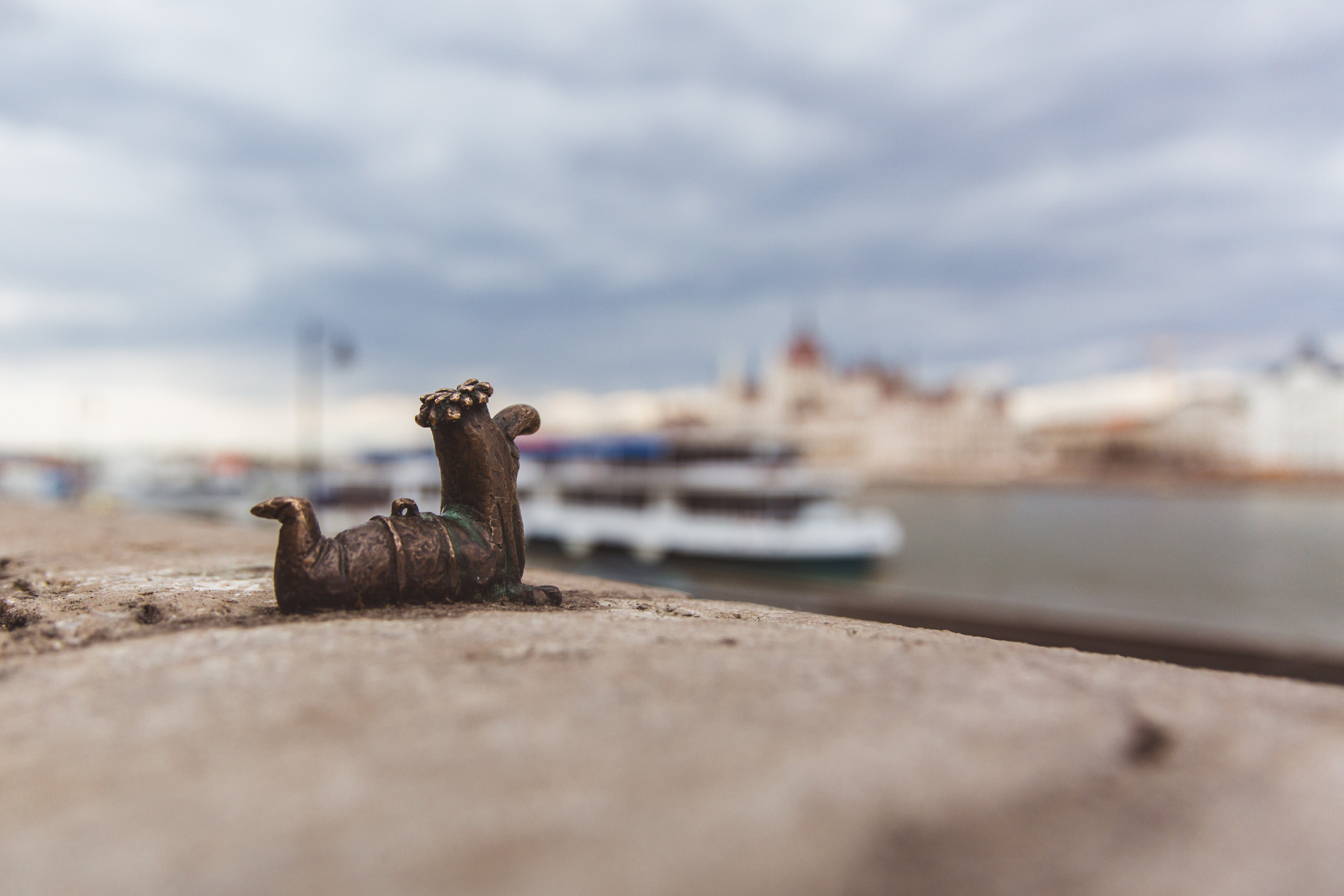 Small statue bronze worm in Budapest, popular Hungarian cartoon figure Fo kukac - chief bait worm. Made and erected by the sculptor Mihajlo Kolodko