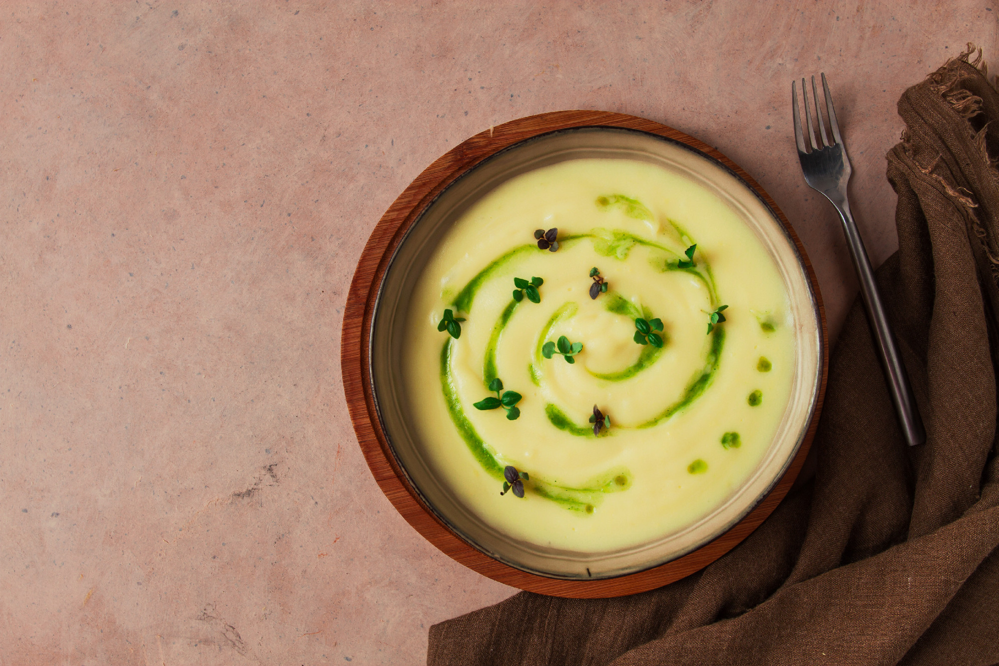 Mashed potatoes, with green butter and micro greenery, homemade, on a beige table, no people, top view,