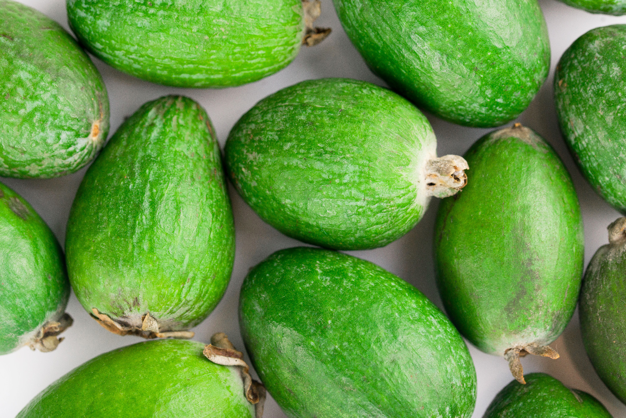 Juicy and ripe feijoa isolated on a white background. Healthy autumn fruit.