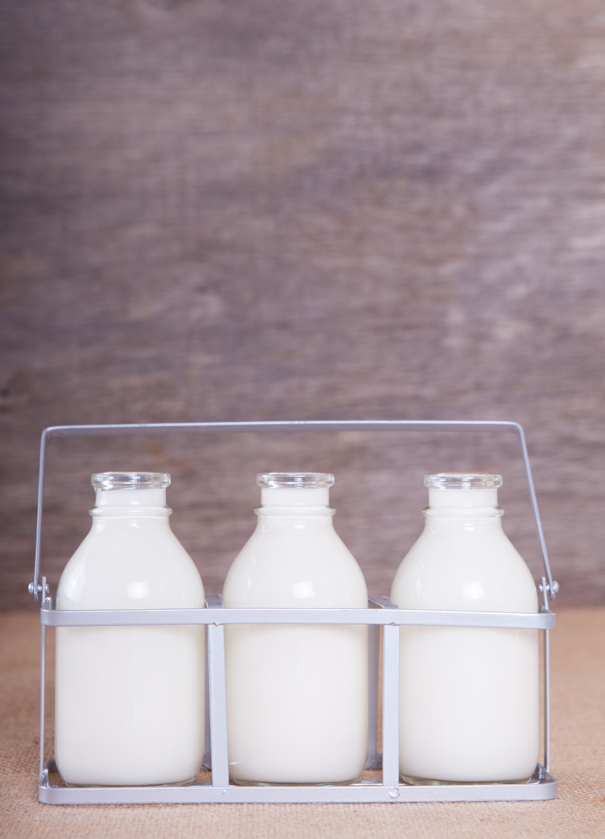 Three full milk bottles on the table