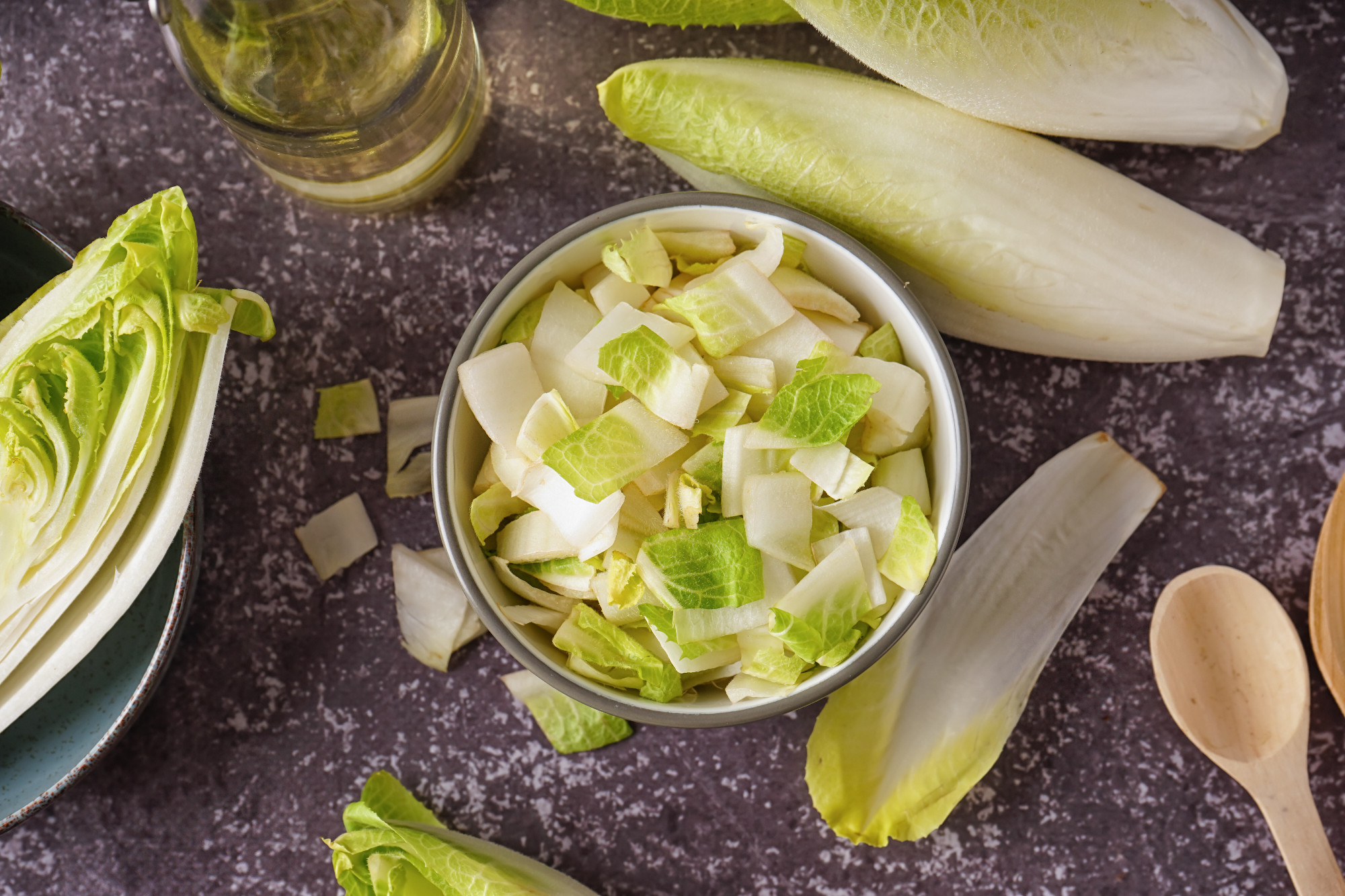 Bowl of cut fresh endive on grunge background�