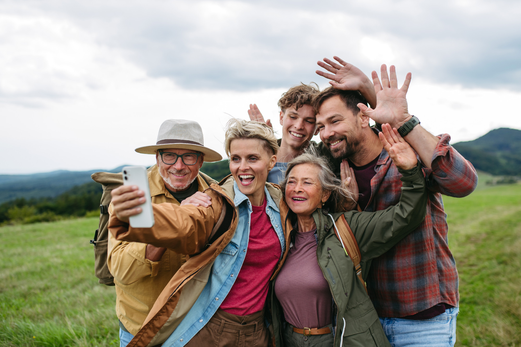 Family taking selfie on hiking trip in the nature.