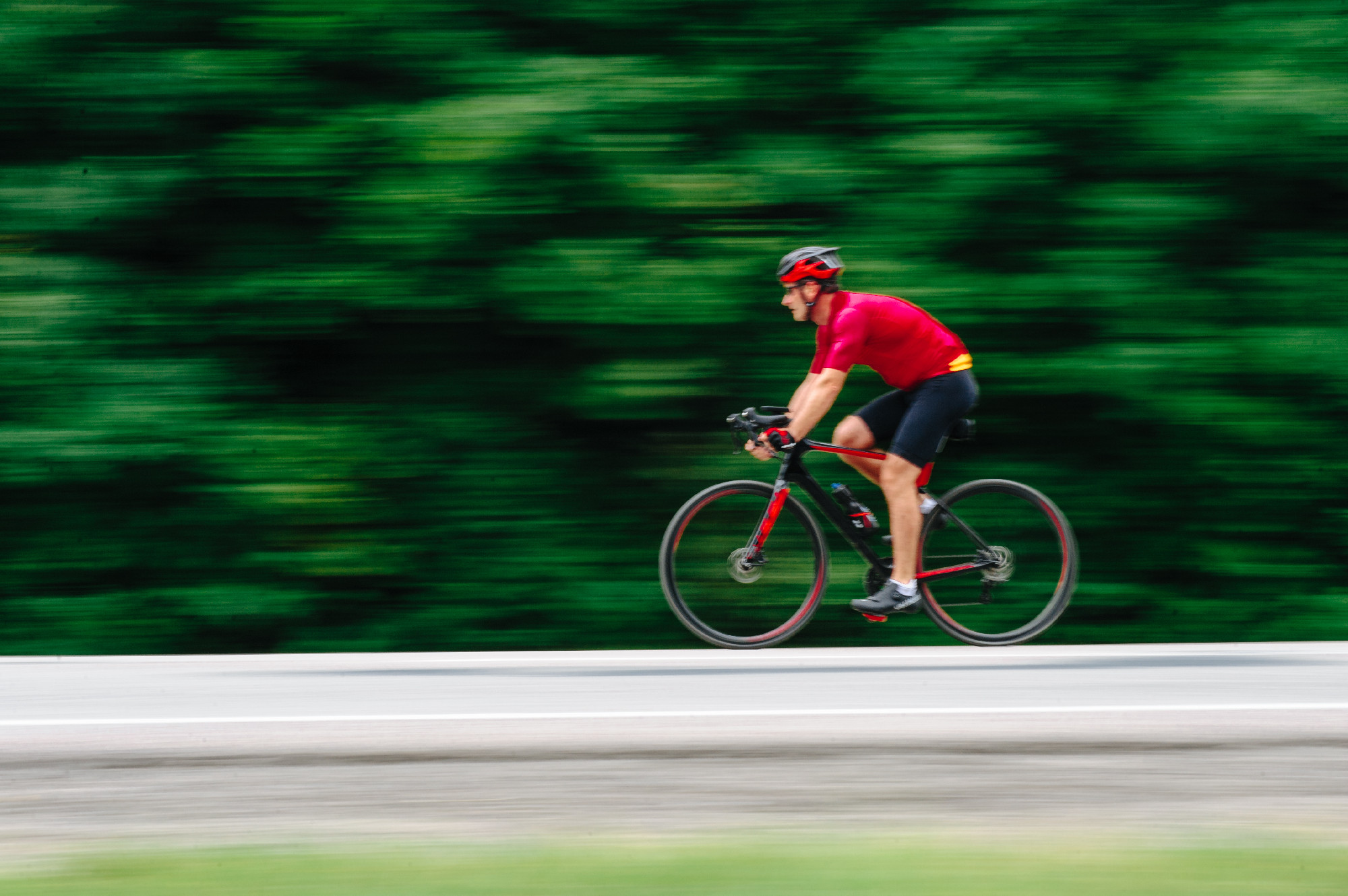 Triathon biking cyclist triathlete riding racing bike during ironman competition.