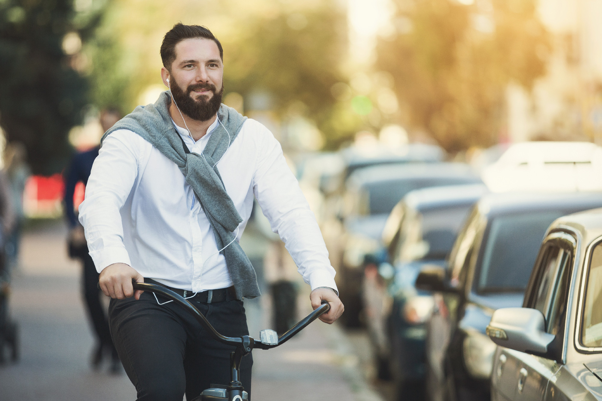 Handsome hipster enjoying city ride by bicycle