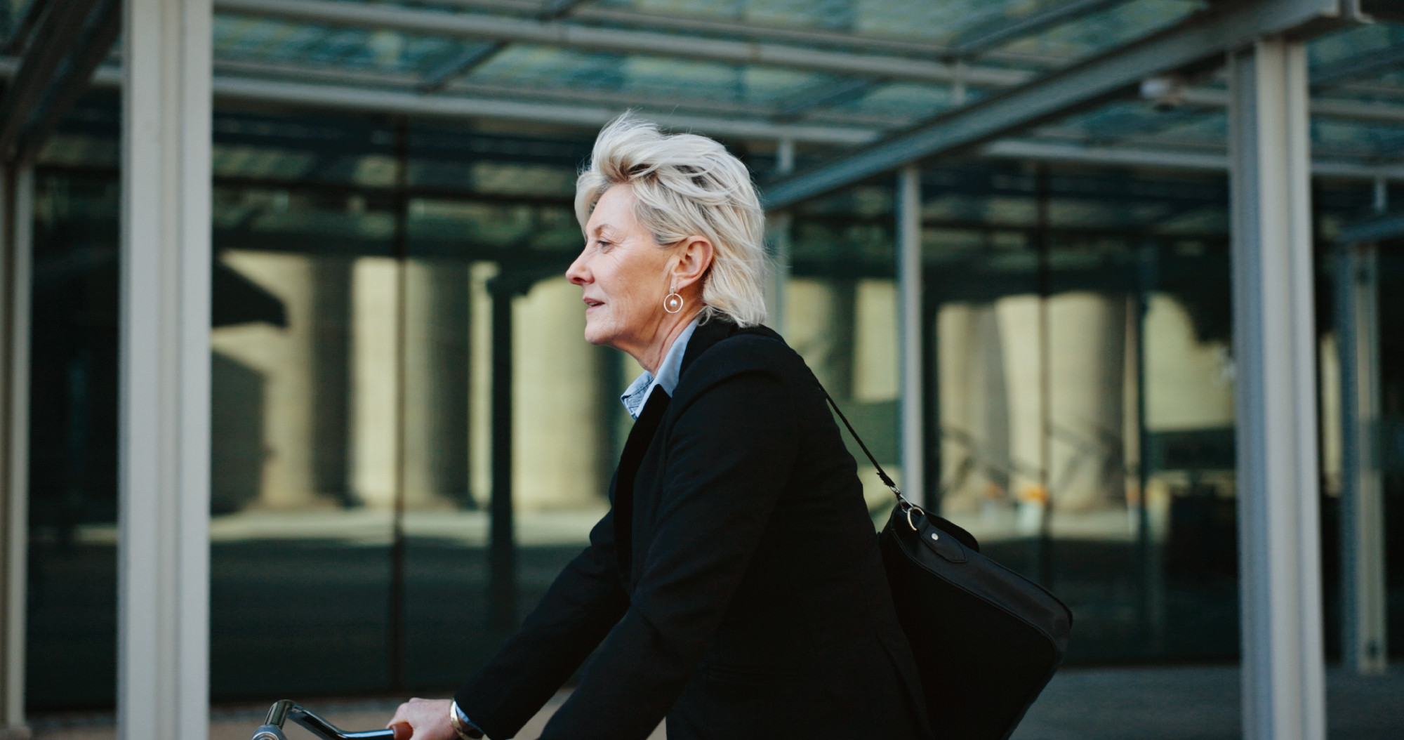 Bicycle, outdoor and mature businesswoman in city with travel, journey or trip to office building. Commuting, cycle and professional female executive with eco friendly transport to work in urban town