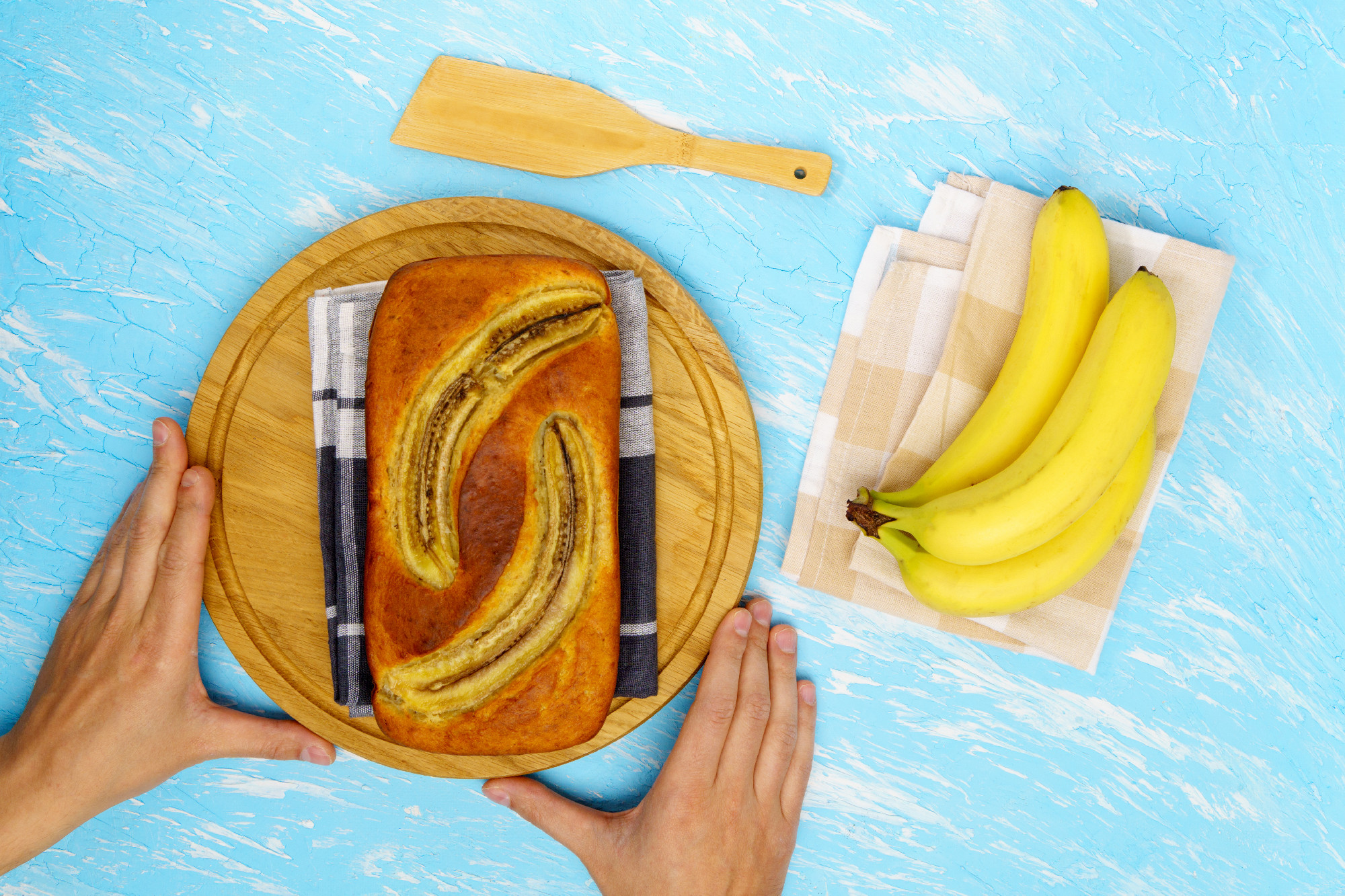 Banana bread on cutting board with Ingredients for Baking. Top view