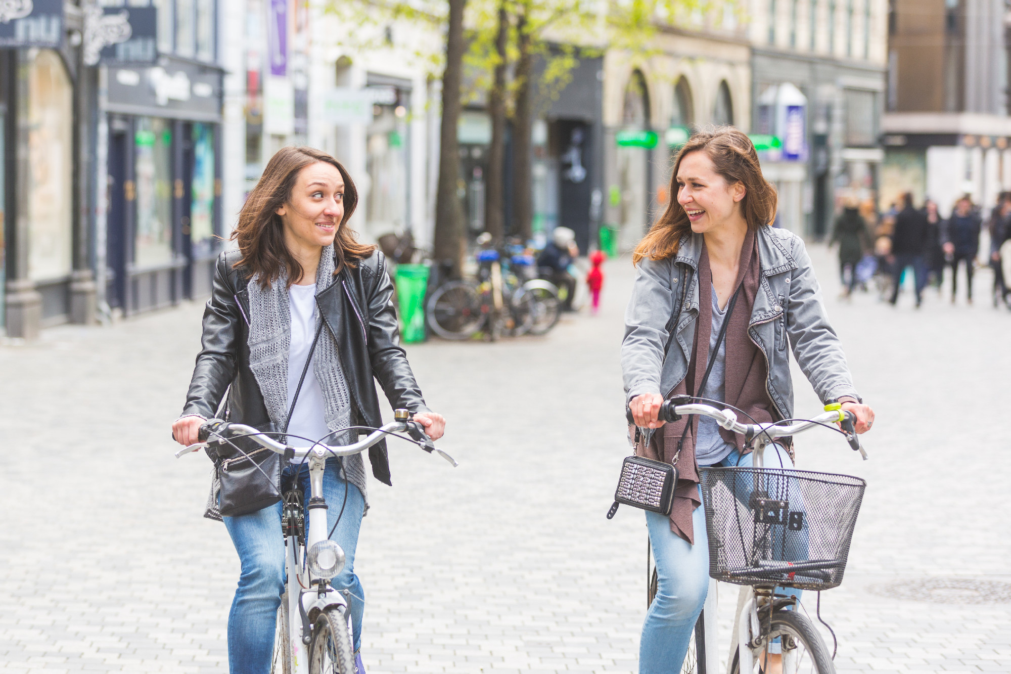 Two women going by bike in Copenhagen.