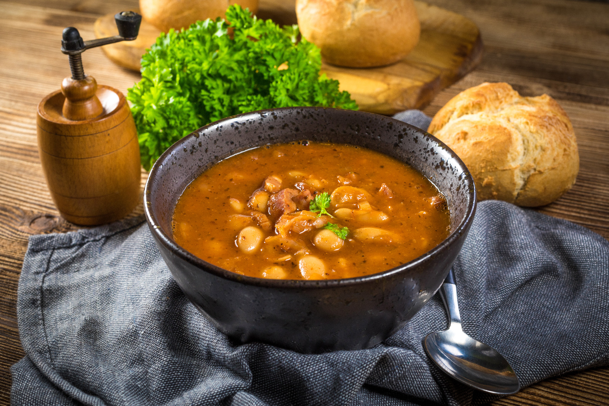 Beans with tomato sauce, bacon and sausage.