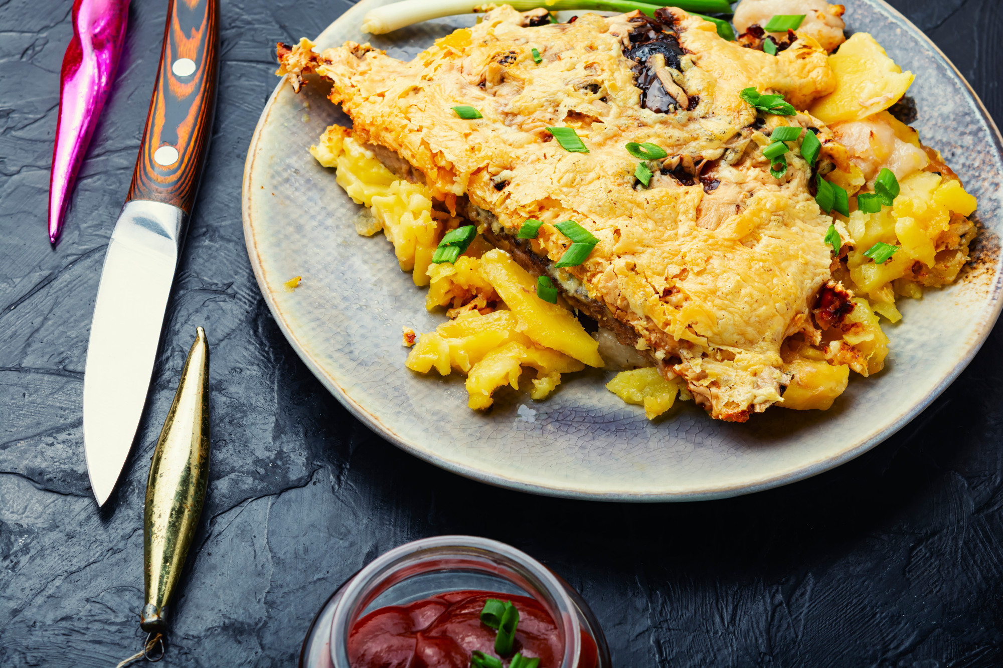 Baked meat with potatoes and cheese.