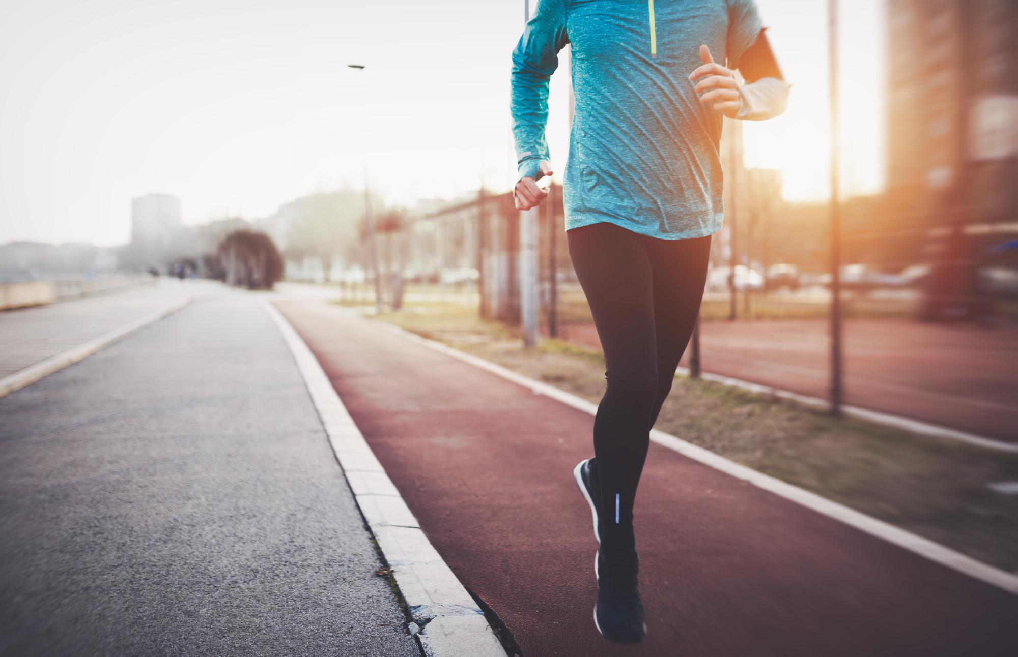 Handsome sportsman exercising outdoor by jogging